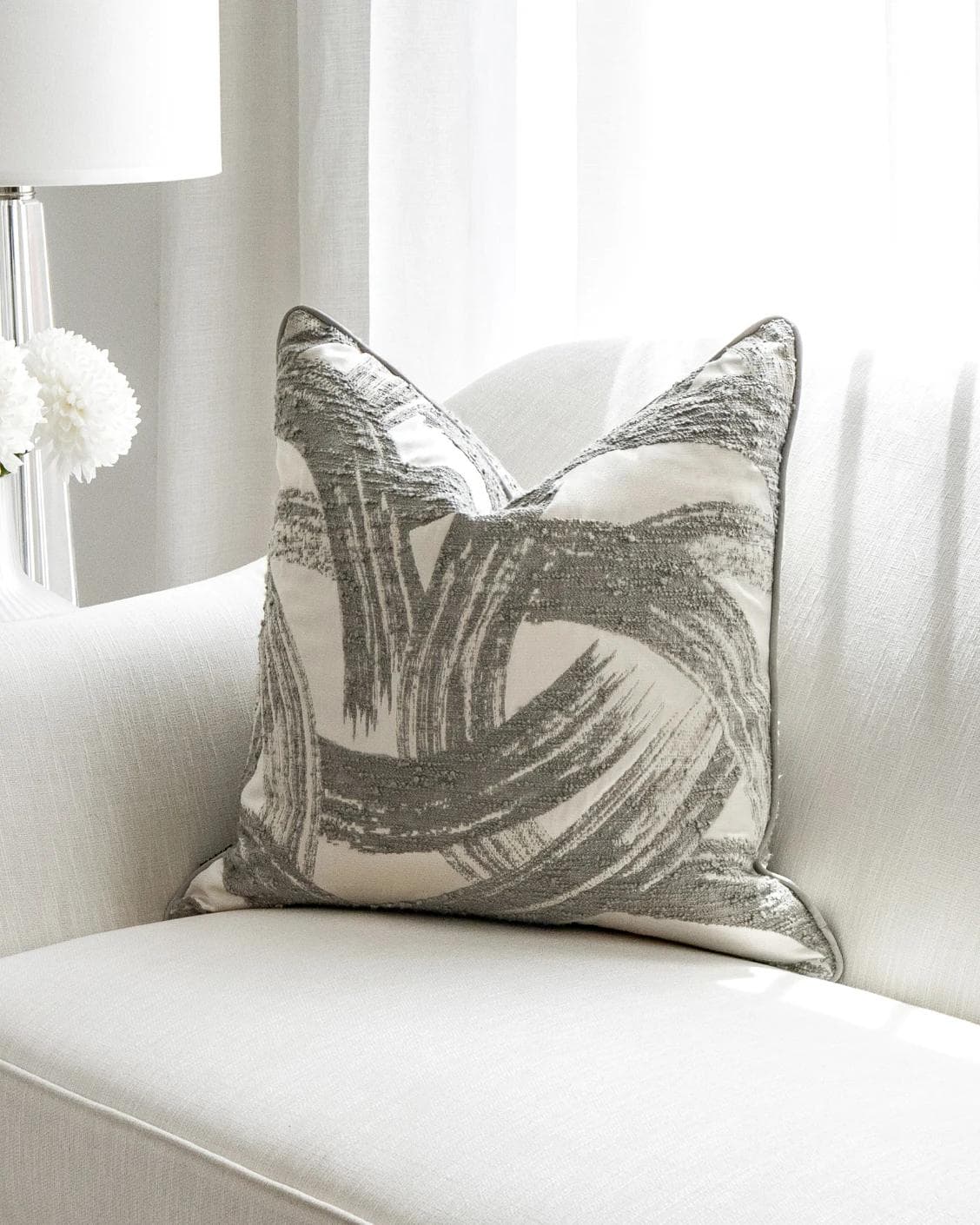 Tanya Laurent cushion in white and grey, shown in a lifestyle front view as image 5