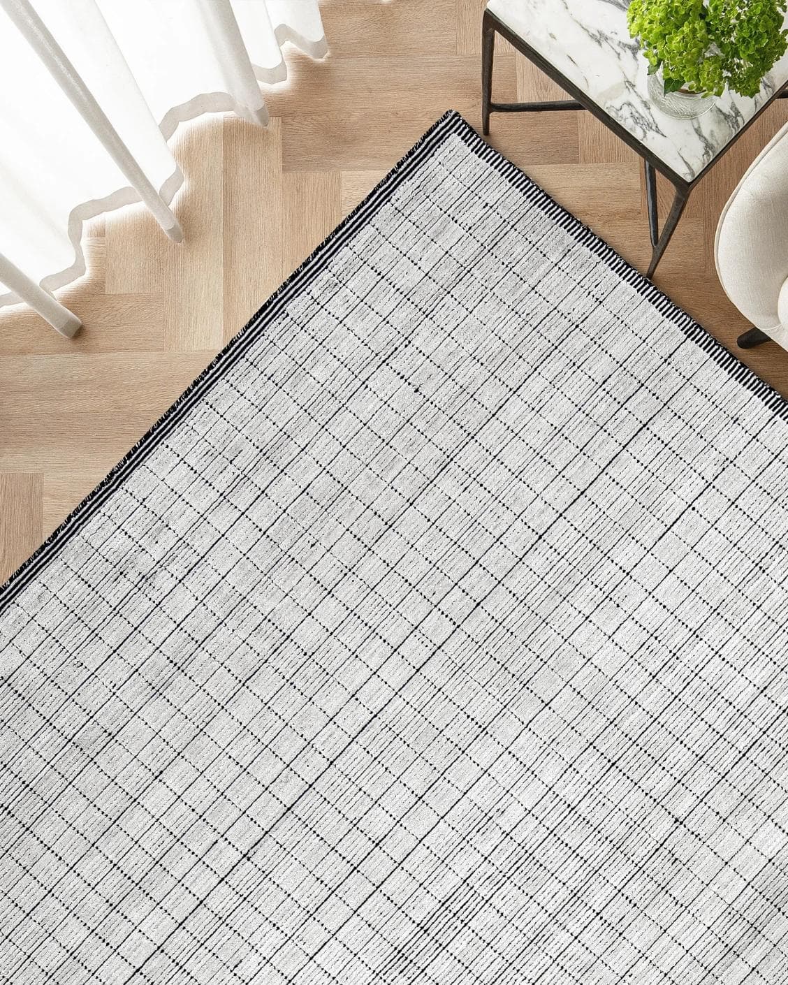 Taylor Bianca carpet in black and white, shown in a lifestyle top view as image 2