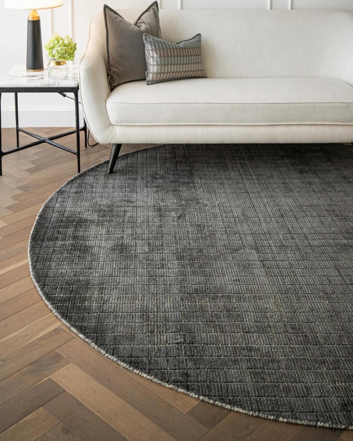 Taylor Ebony Round carpet in black and grey, shown in a lifestyle front view