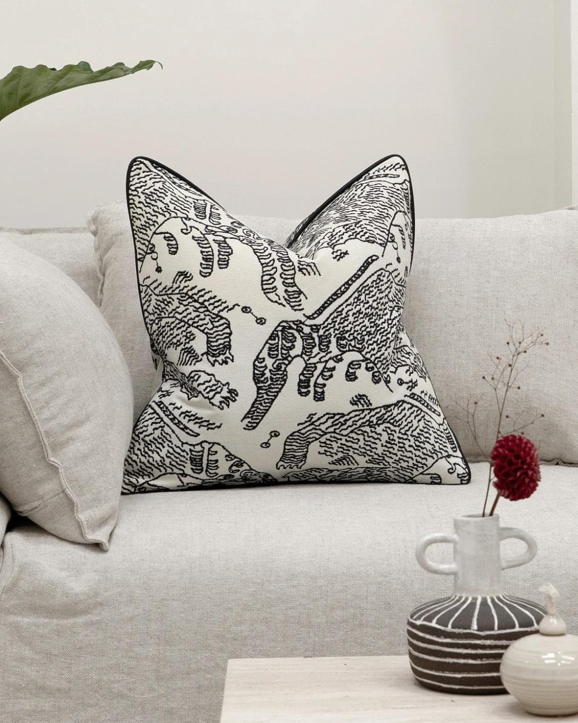 Tessa Steele cushion in ivory and charcoal, shown in a lifestyle front view as image 4