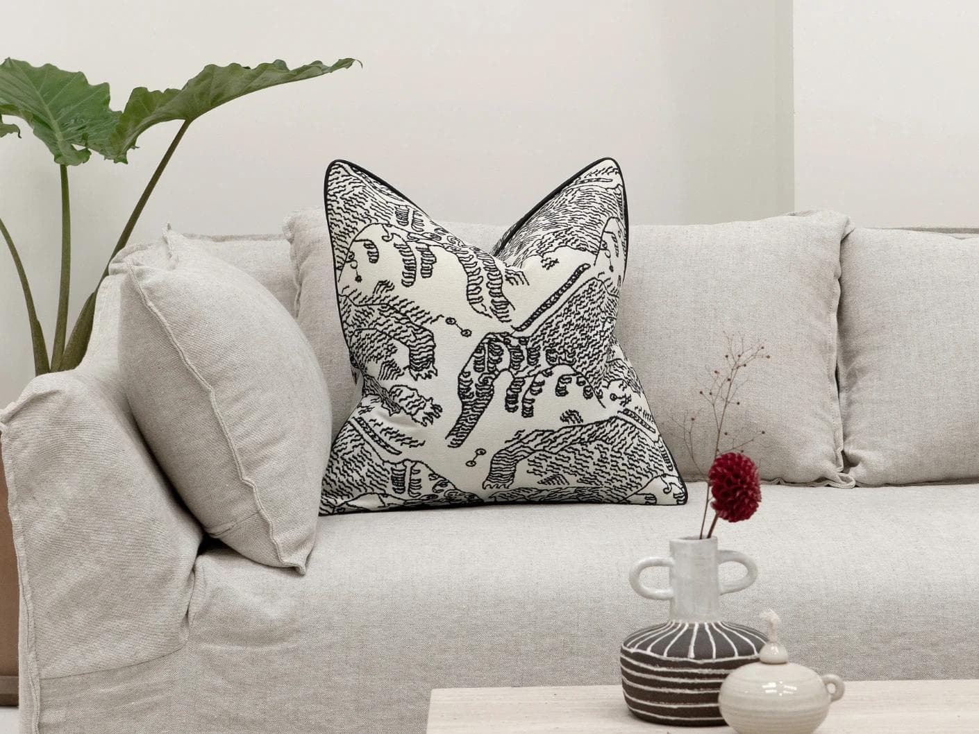 Tessa Steele cushion in ivory and charcoal, shown in a lifestyle front view as image 4