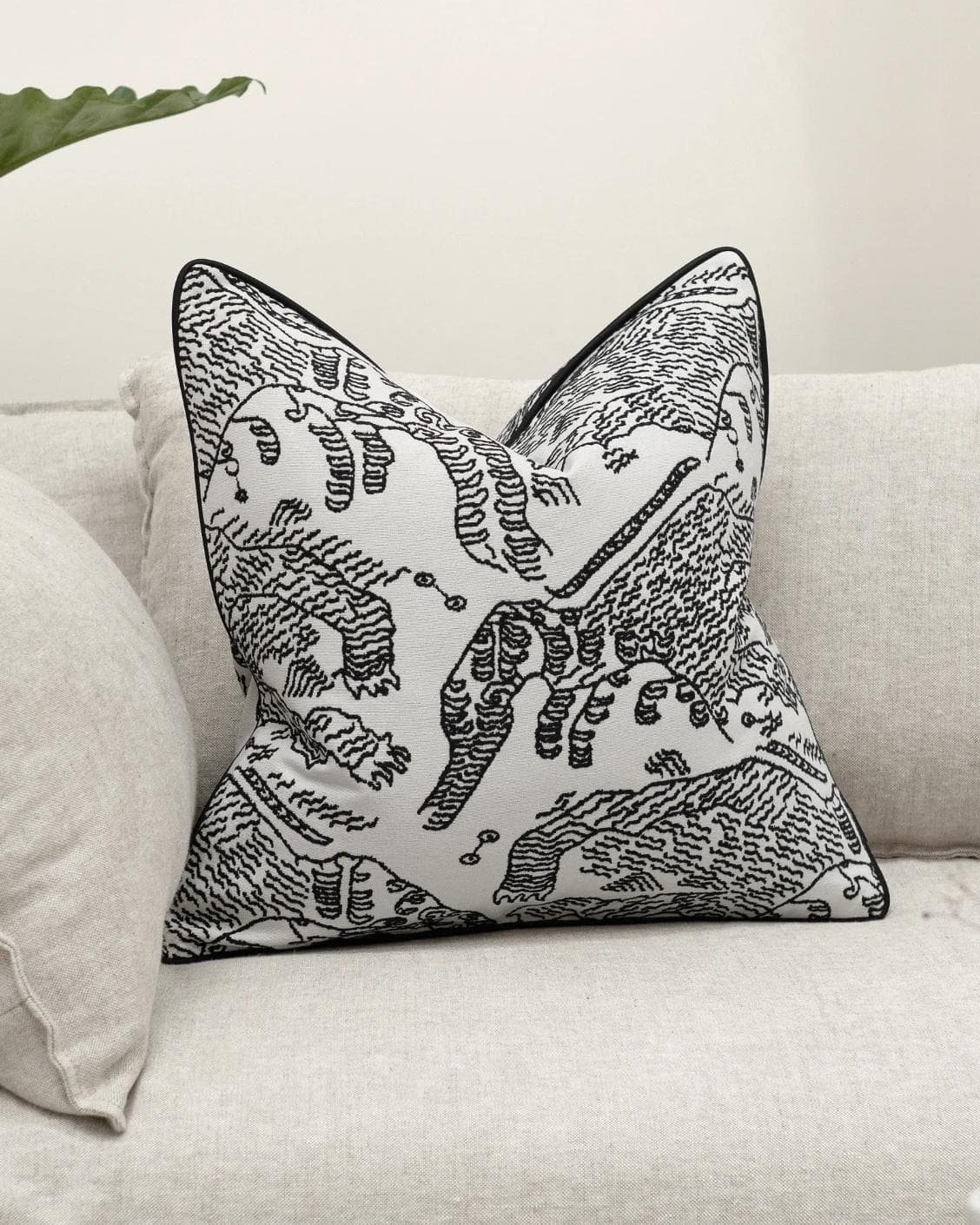 Tessa Steele cushion in ivory and charcoal, shown in a lifestyle front view as image 2