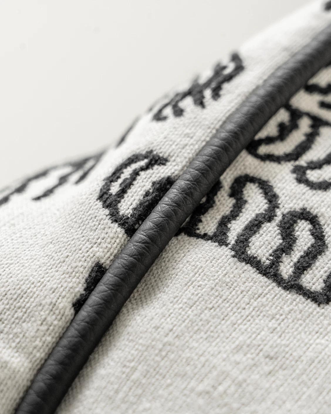 Tessa Steele cushion in ivory and charcoal, shown in a product close-up as image 9