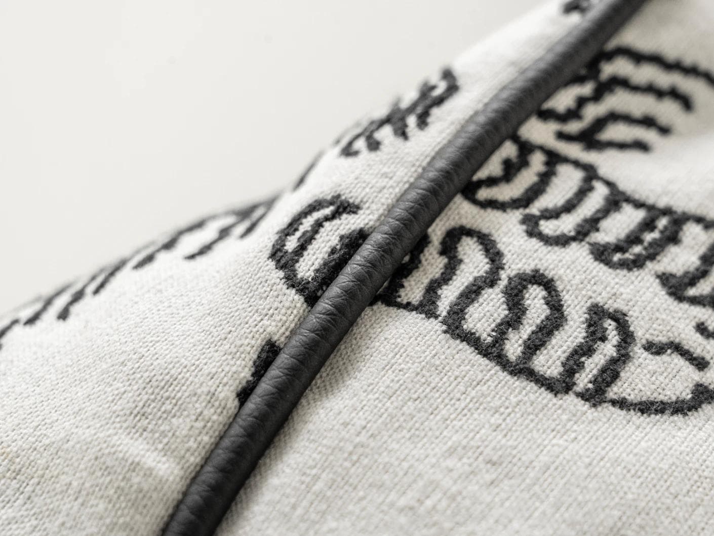 Tessa Steele cushion in ivory and charcoal, shown in a product close-up as image 9