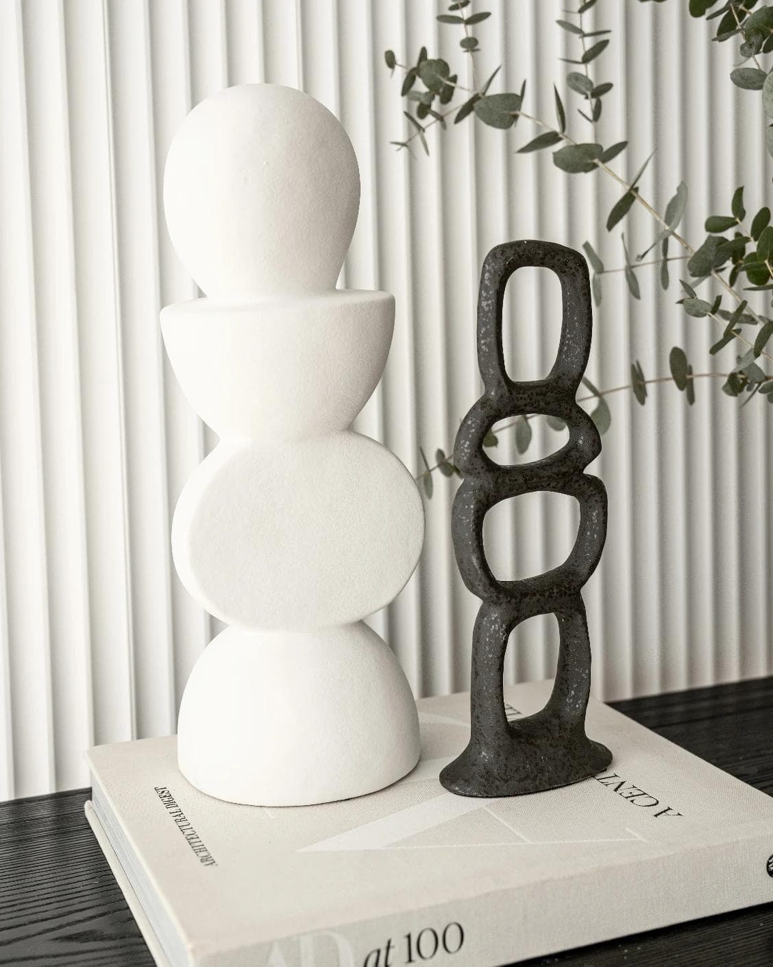 Tetra Laurian Bundle statues and sculptures in white and black, shown in a lifestyle left view as image 2