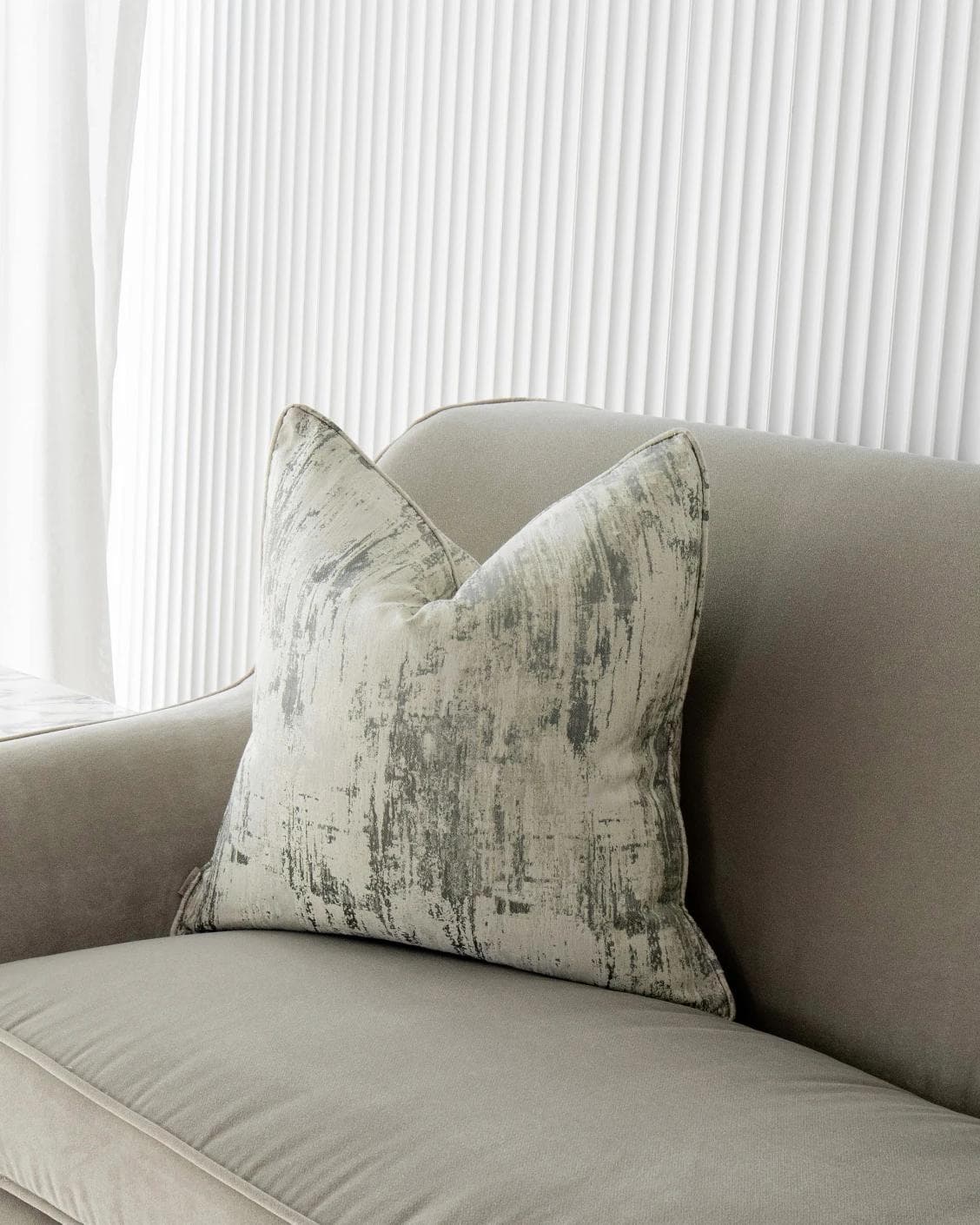 Theo Laurent cushion in grey and white, shown in a lifestyle front view as image 5