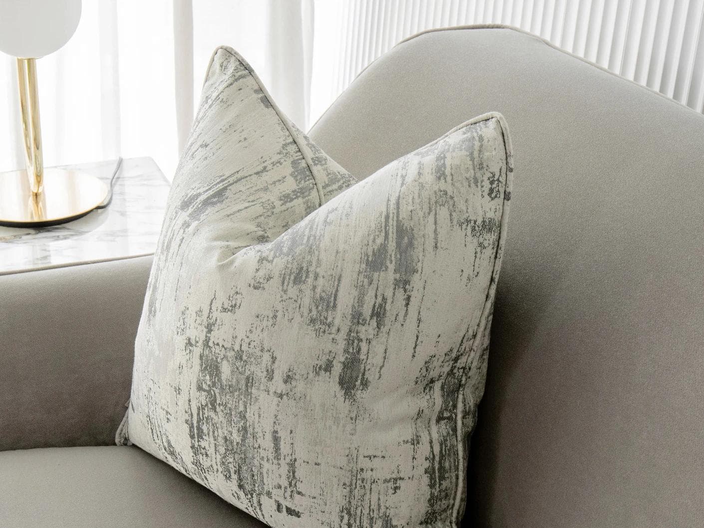 Theo Laurent cushion in grey and white, shown in a lifestyle right view as image 2