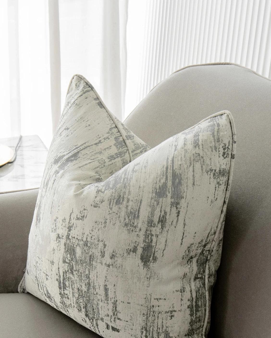 Theo Laurent cushion in grey and white, shown in a lifestyle right view as image 2