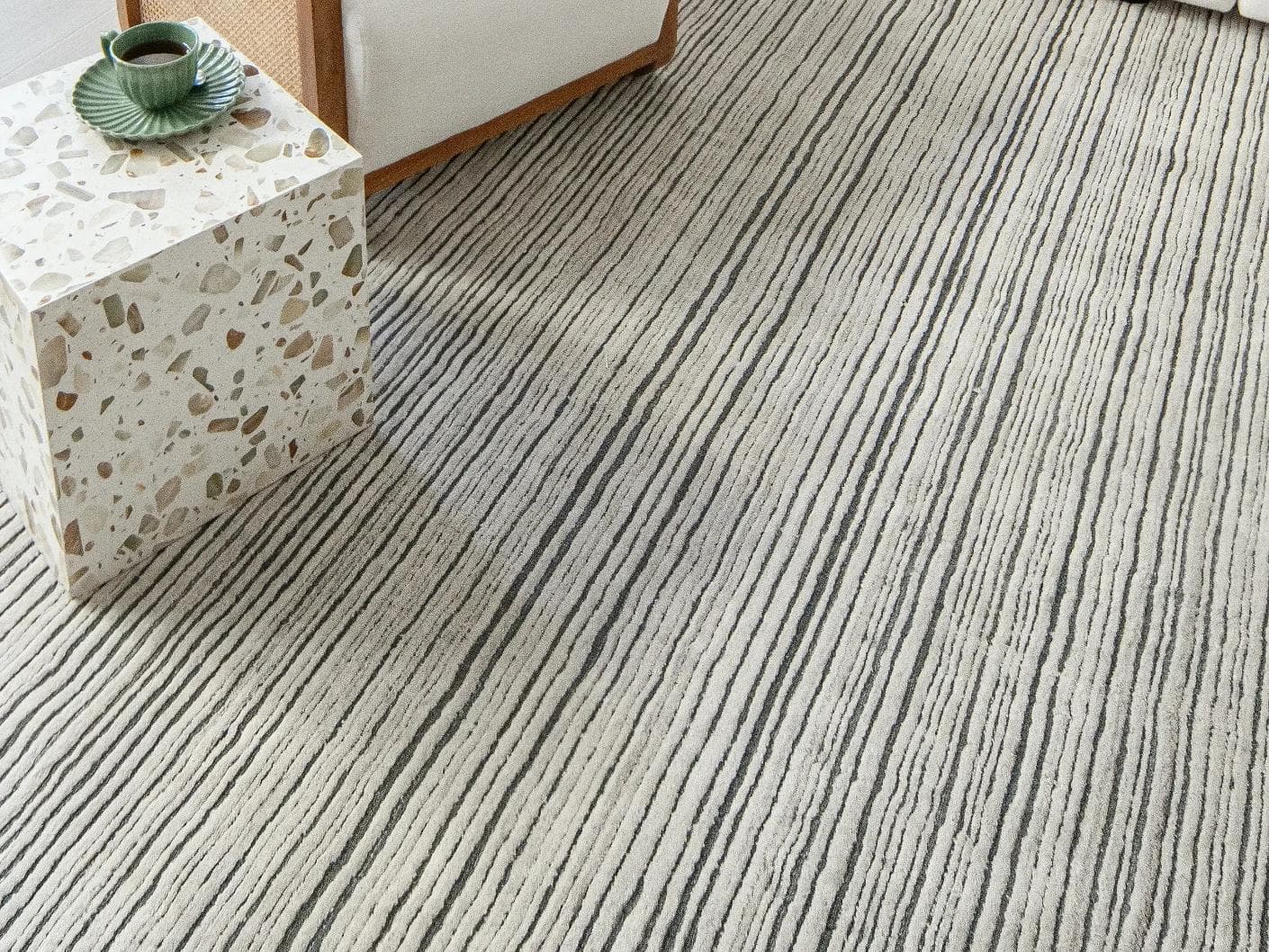 Theodore Ashton carpets in grey and ivory, shown in a lifestyle close-up as image 2