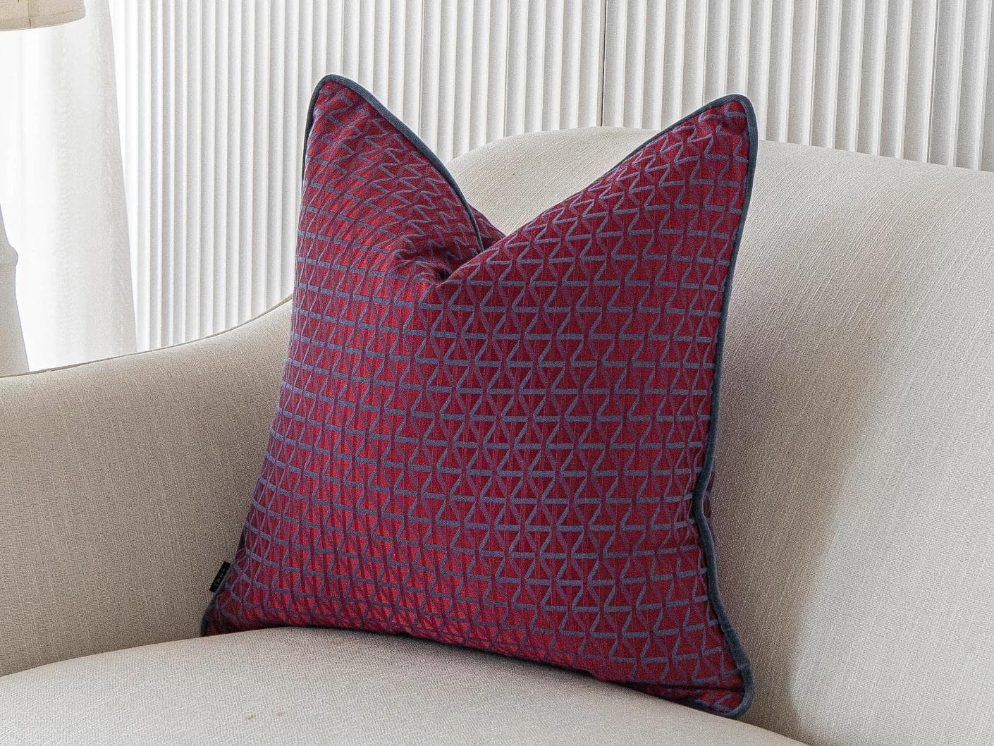 Thylane Canova I cushion in red and purple, shown in a lifestyle front view as image 2