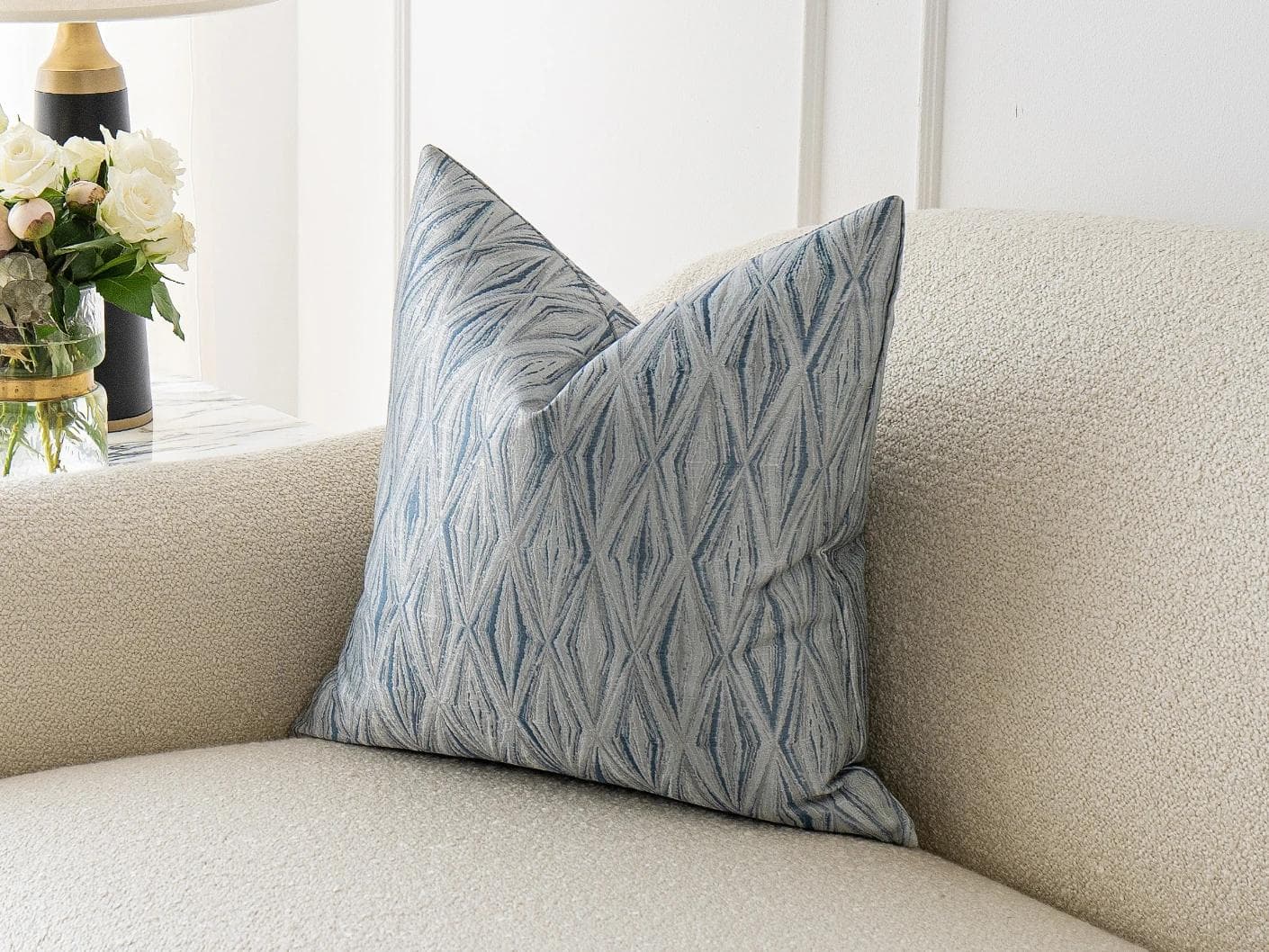 Titus Matisse cushion in silver and blue, shown in a lifestyle front view as image 2