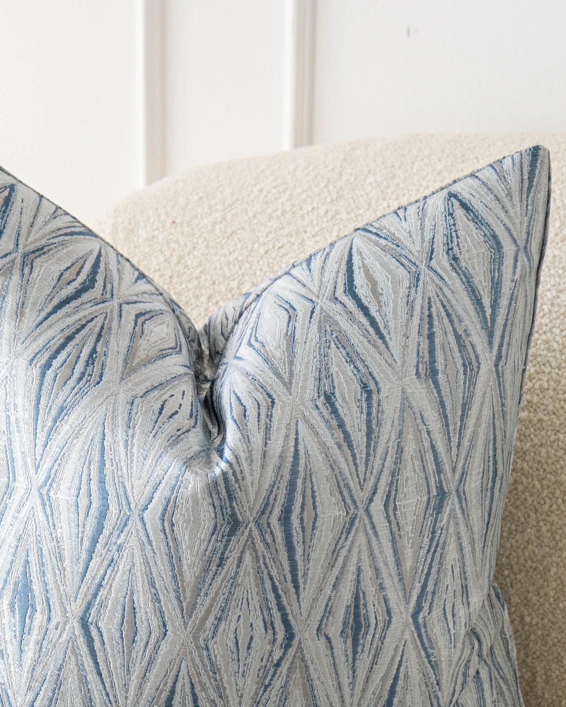 Titus Matisse cushion in silver and blue, shown in a lifestyle front view as image 5