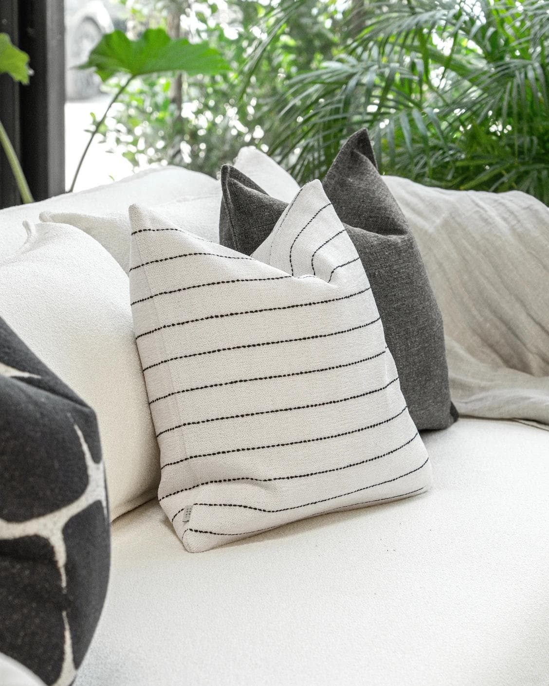 Tova Bundle cushion in black and white, shown in a product left view as image 6