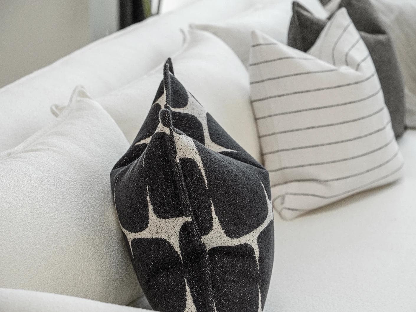 Tova Bundle cushion in black and white, shown in a product left view as image 7