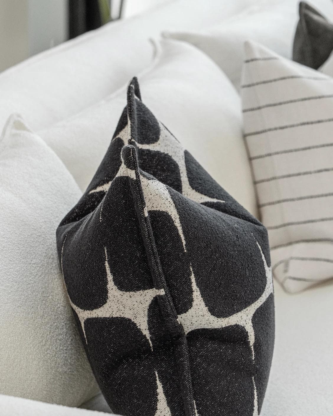 Tova Bundle cushion in black and white, shown in a product left view as image 7