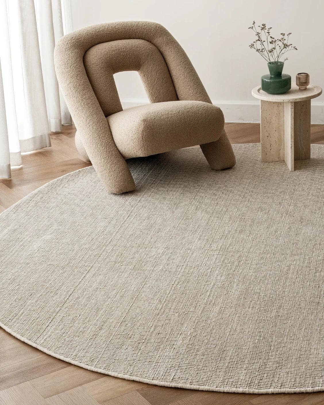 Treva Stone Round carpet in beige and taupe, shown in a lifestyle front view