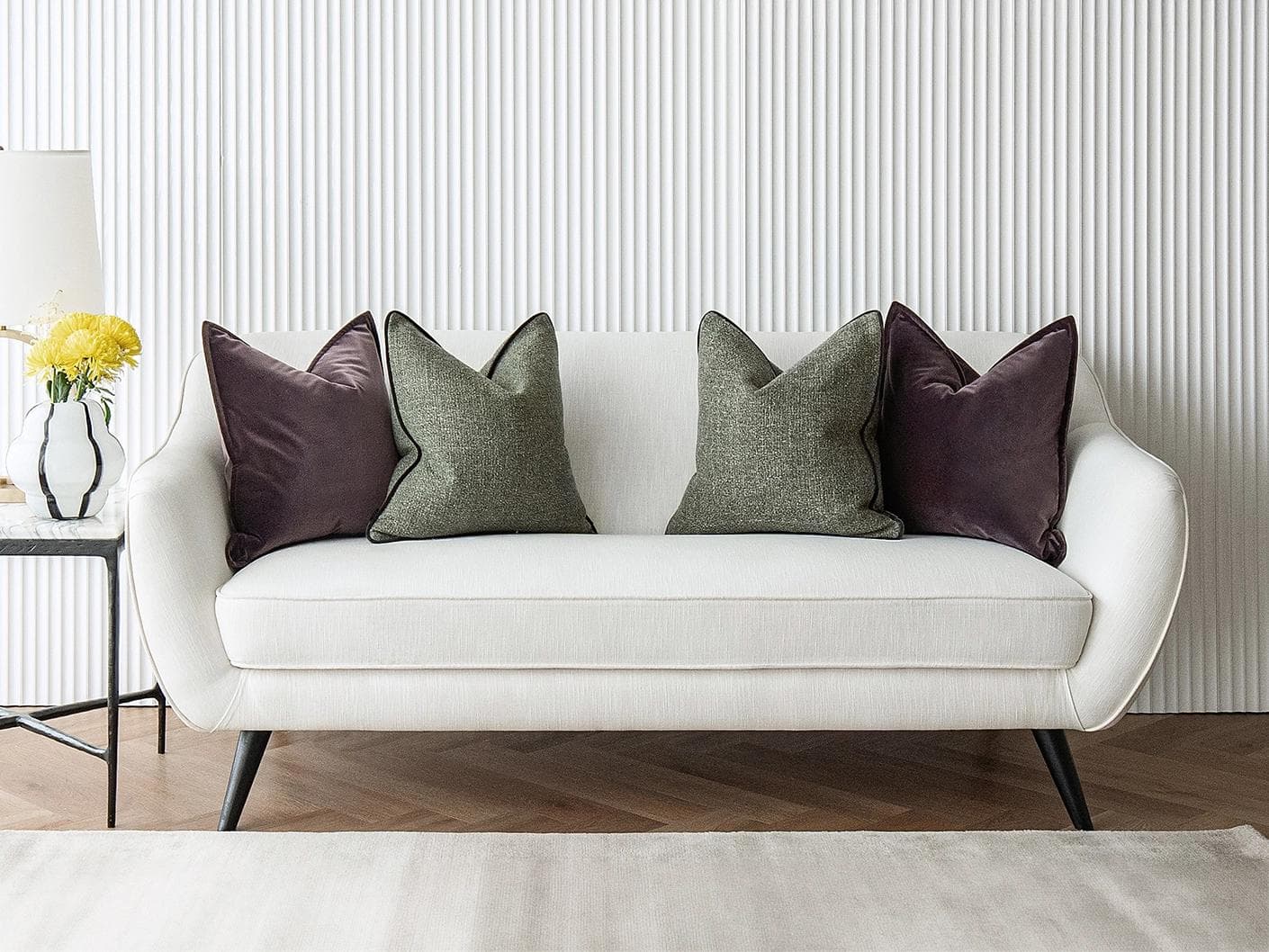 Kamelia Bundle cushion in purple and green, shown in a lifestyle front view as image 2