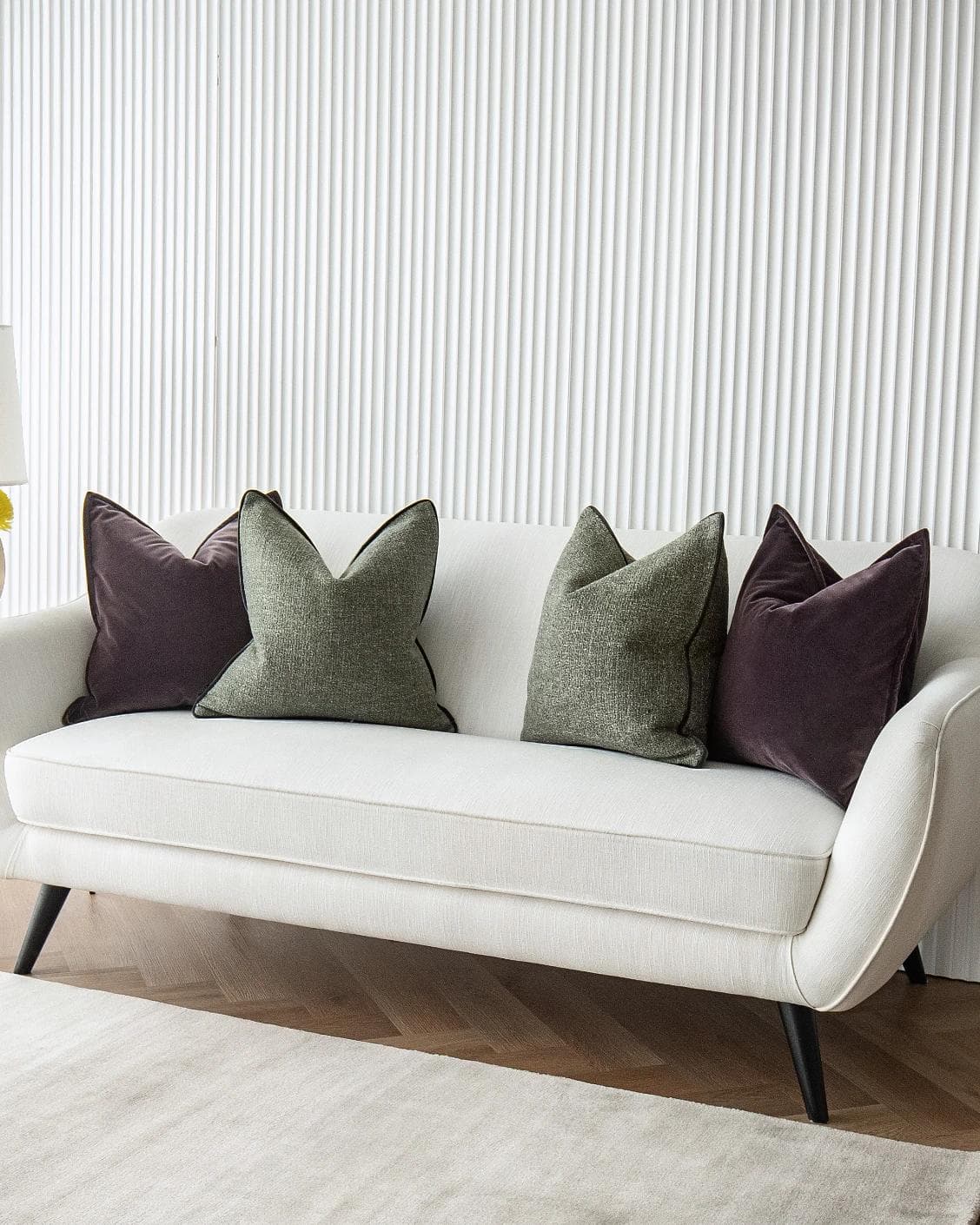 Kamelia Bundle cushion in purple and green, shown in a lifestyle right view as image 4
