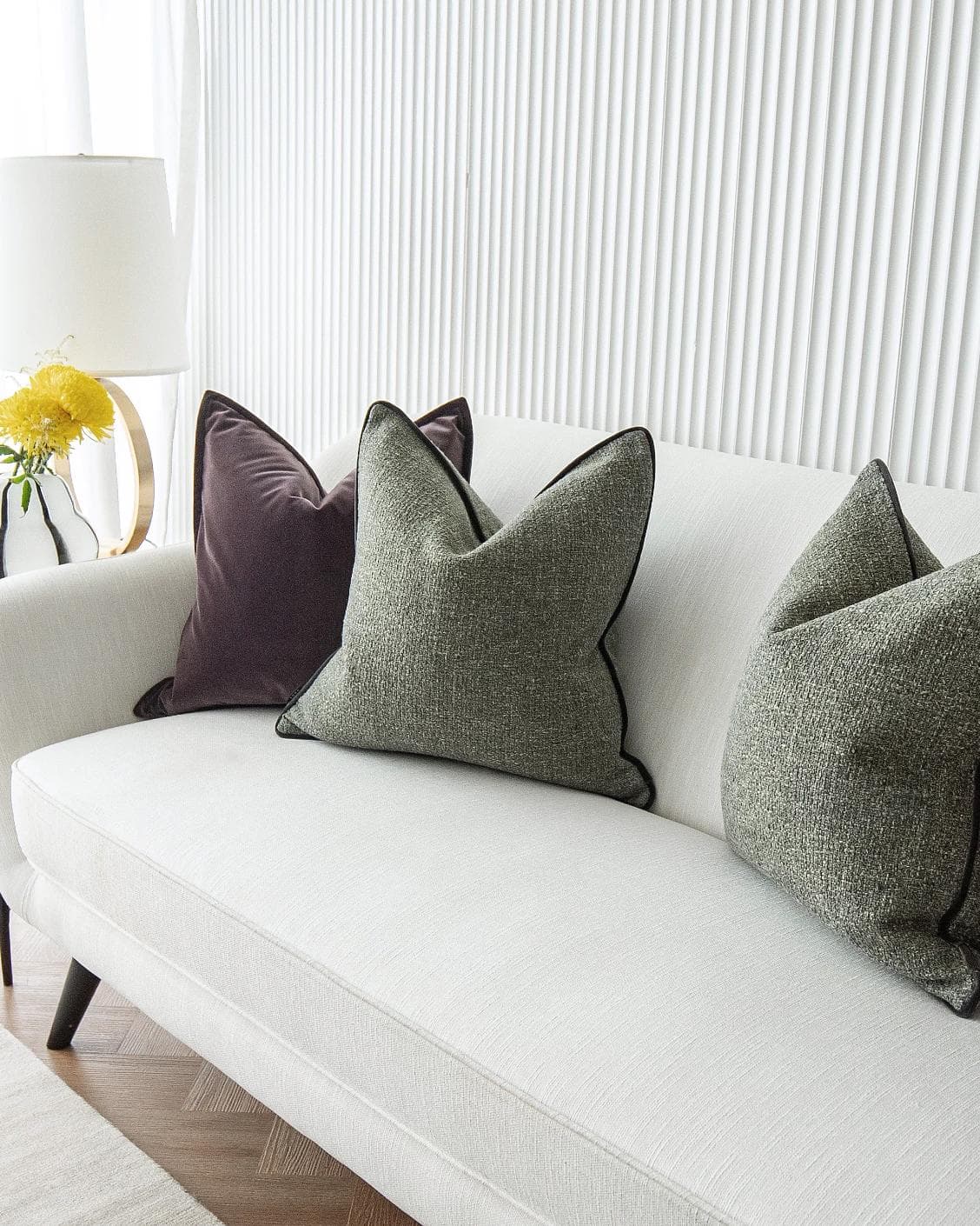 Kamelia Bundle cushion in purple and green, shown in a lifestyle right view as image 5
