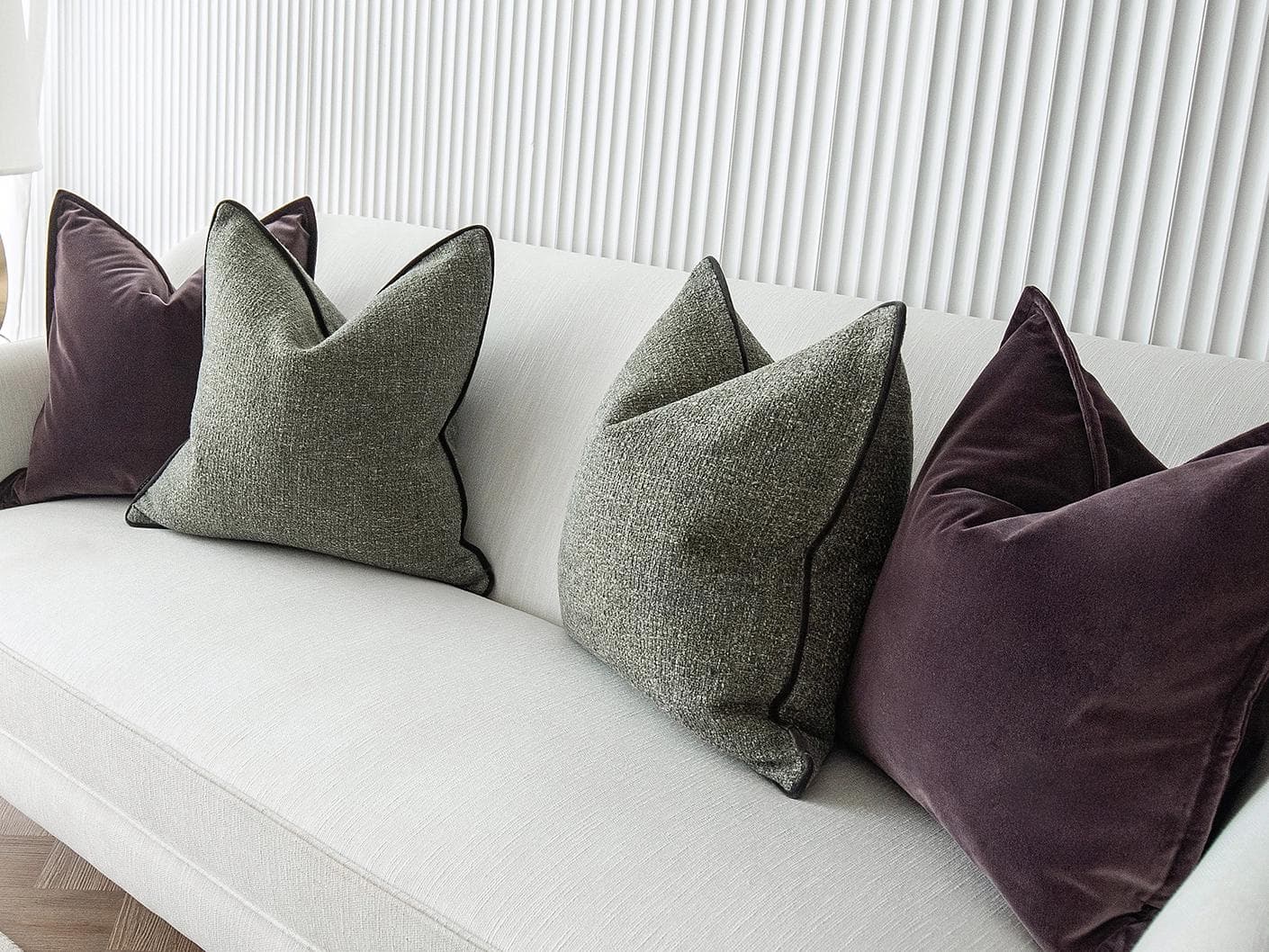 Kamelia Bundle cushion in purple and green, shown in a lifestyle right view as image 5