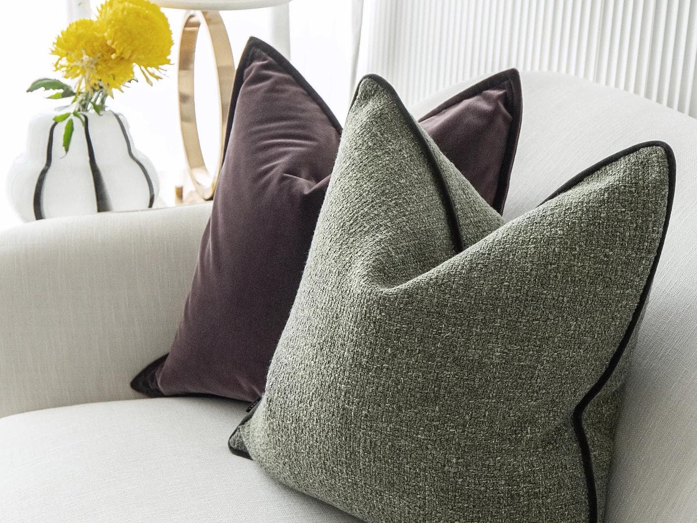 Kamelia Bundle cushion in purple and green, shown in a lifestyle right view as image 6
