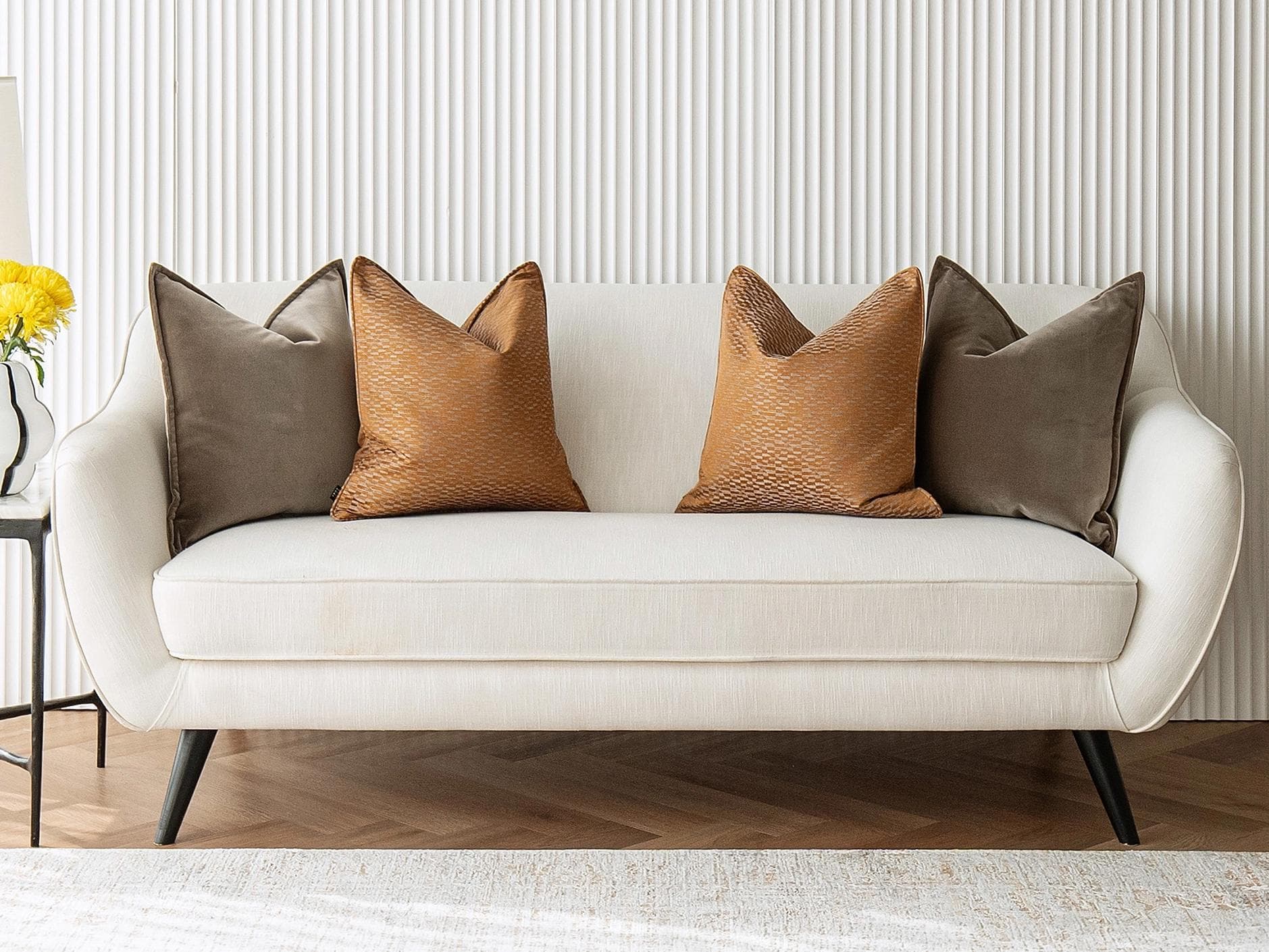 Jora Bundle cushion in brown and orange, shown in a lifestyle front view as image 2