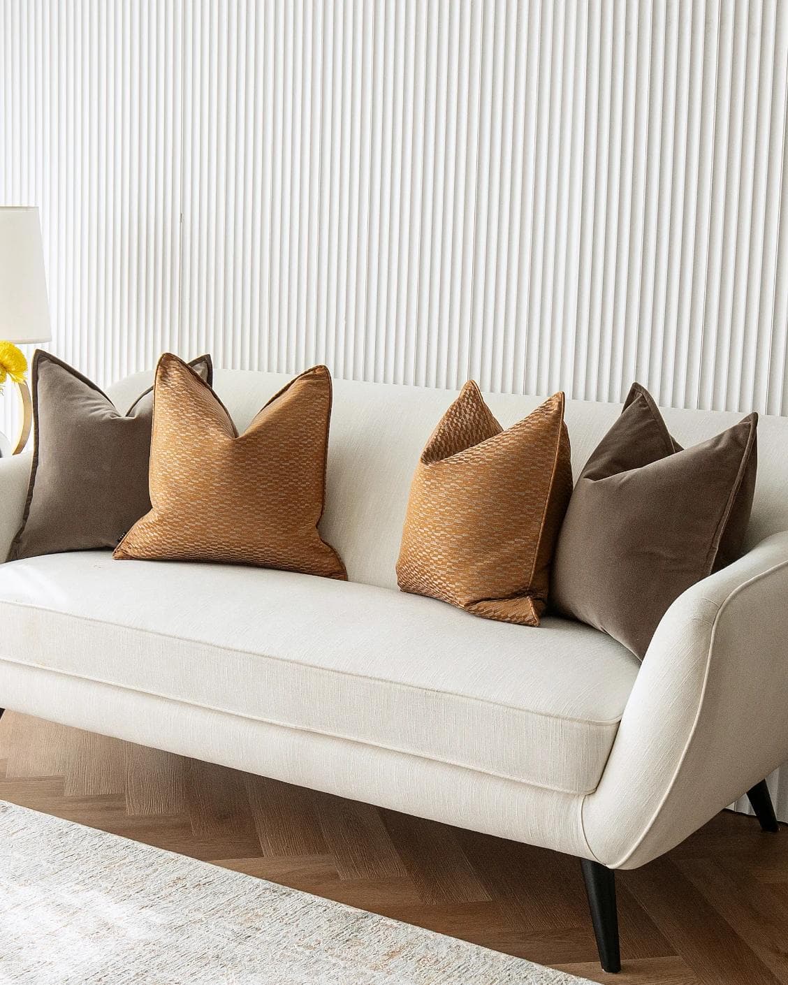 Jora Bundle cushion in brown and orange, shown in a lifestyle right view as image 4