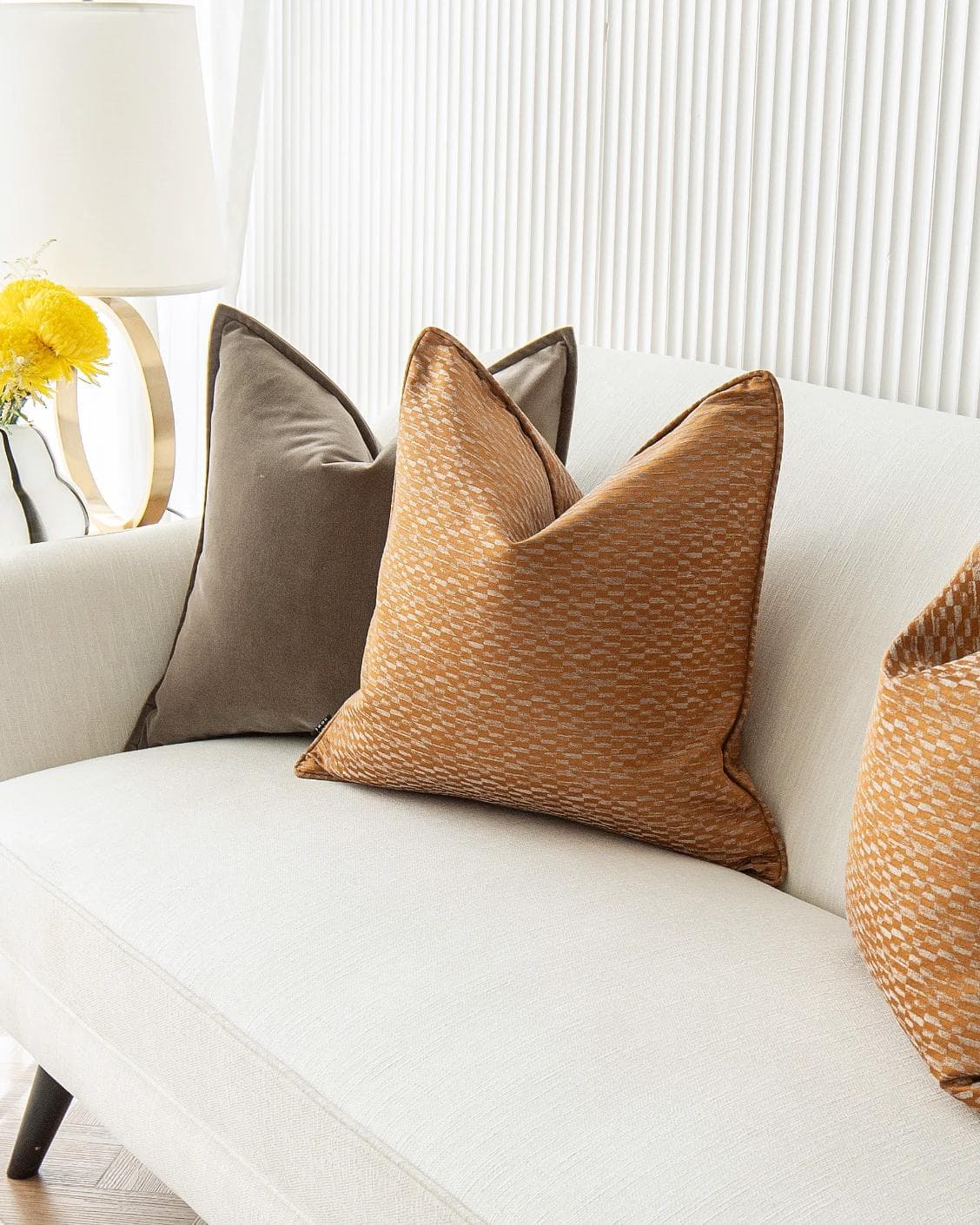 Jora Bundle cushion in brown and orange, shown in a lifestyle right view as image 5