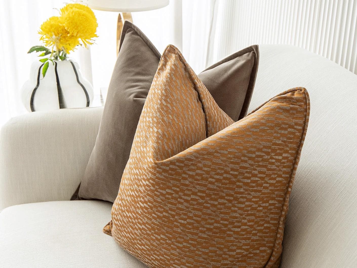 Jora Bundle cushion in brown and orange, shown in a lifestyle right view as image 6