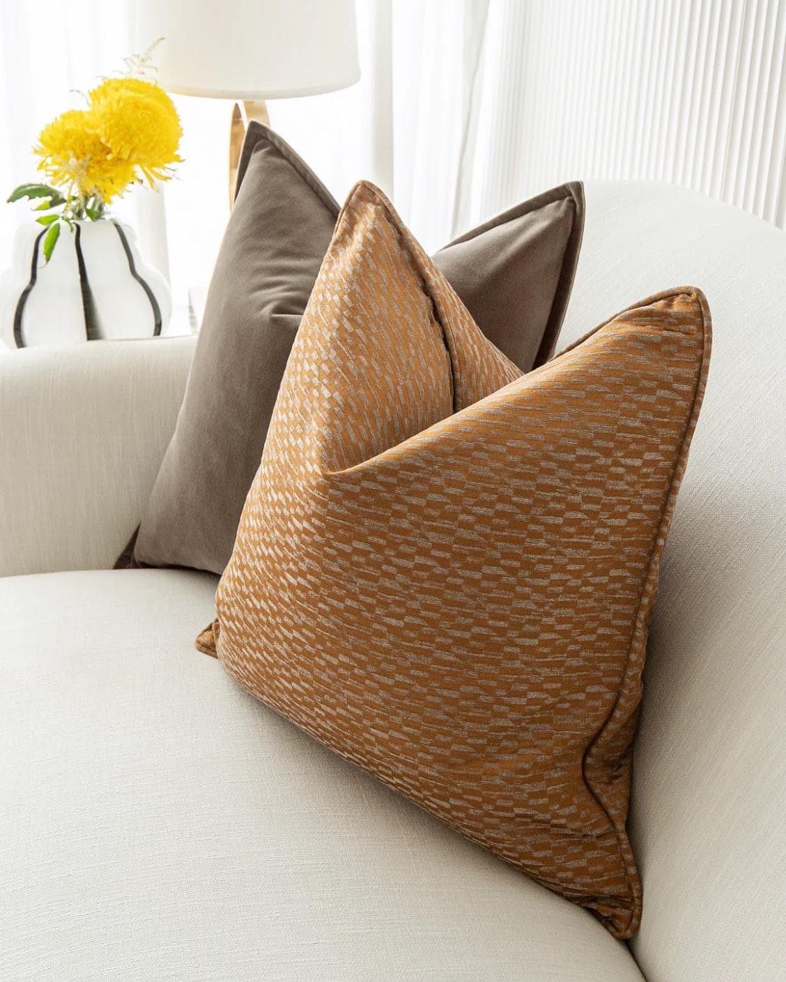 Jora Bundle cushion in brown and orange, shown in a lifestyle right view as image 6