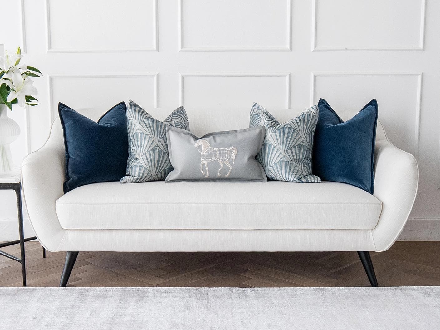 Remi Bundle cushion in blue, silver and white, shown in a lifestyle front view as image 4