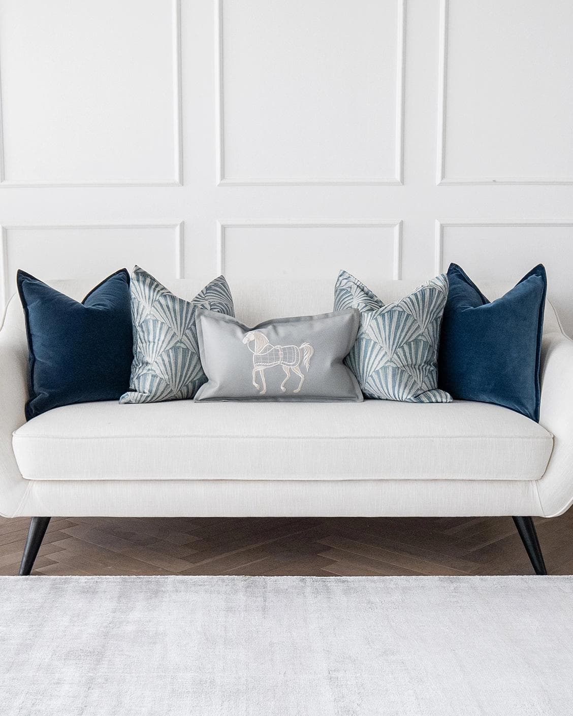 Remi Bundle cushion in blue, silver and white, shown in a lifestyle front view as image 4