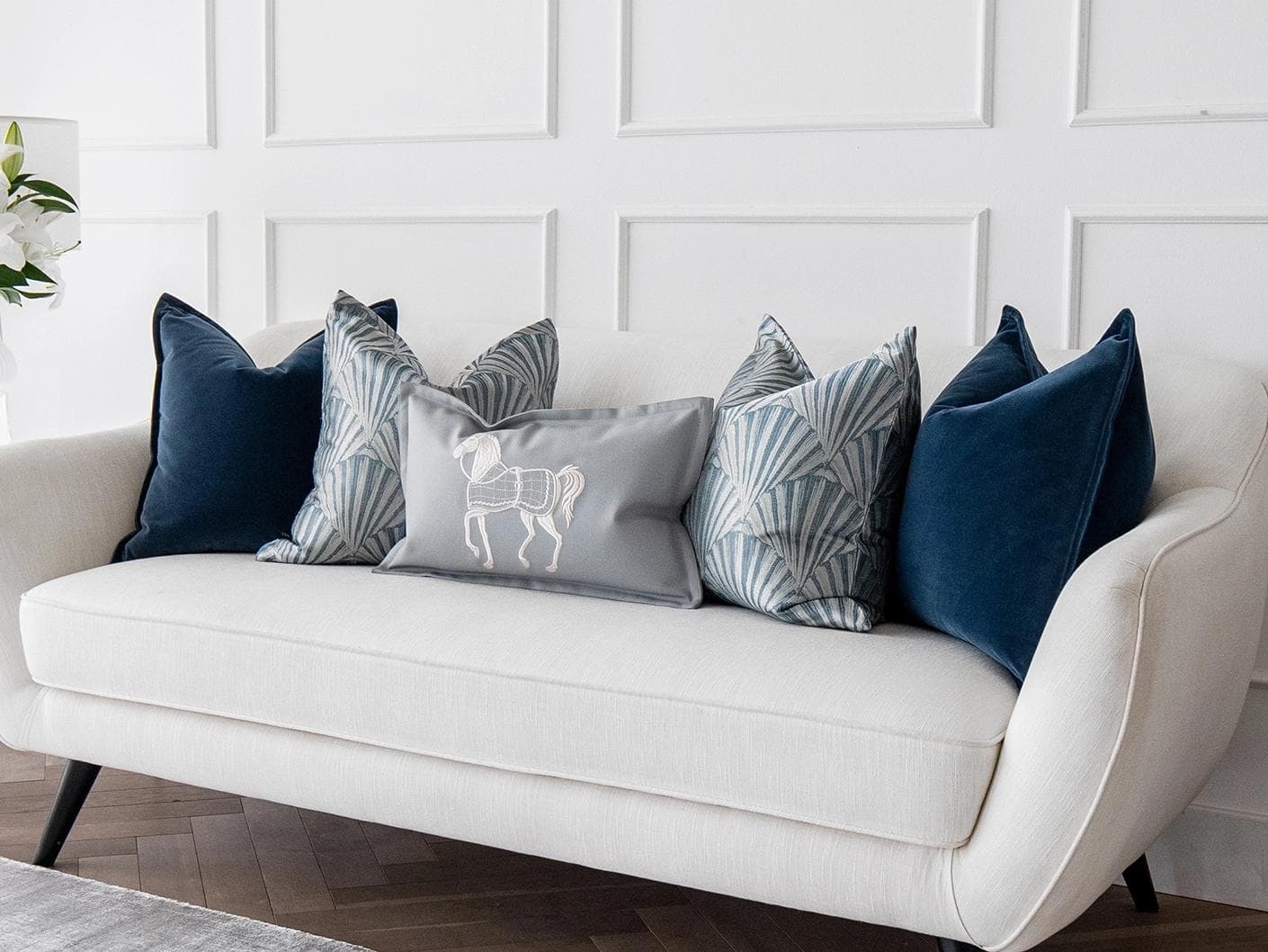 Remi Bundle cushion in blue, silver and white, shown in a lifestyle right view as image 2
