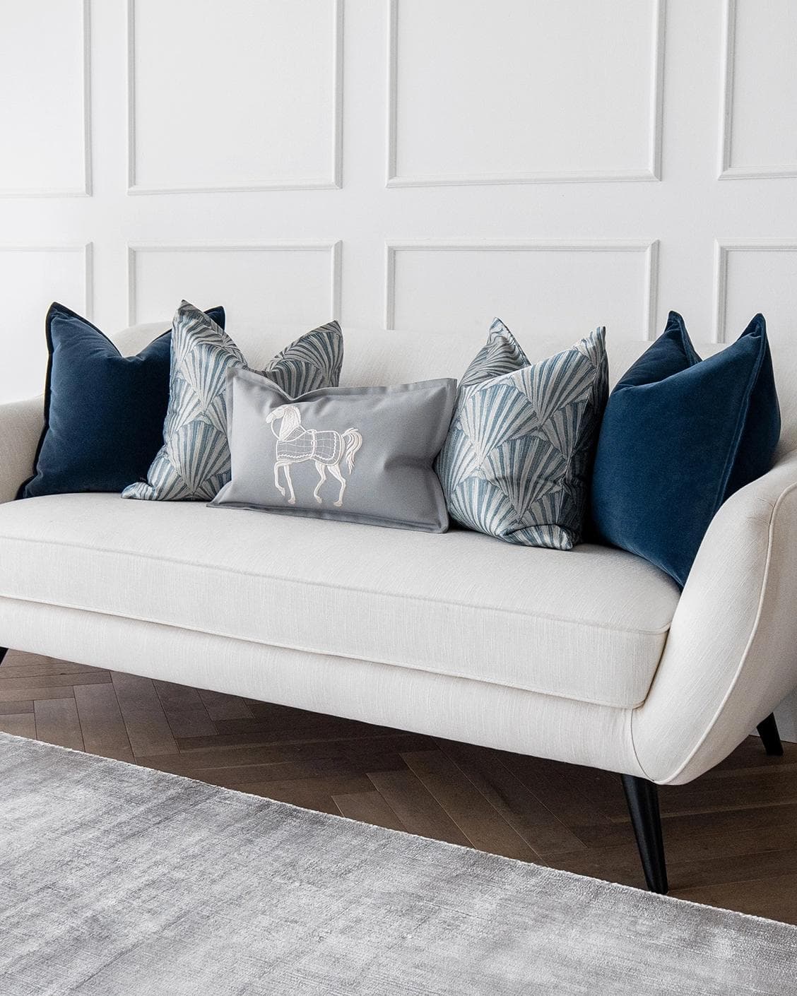 Remi Bundle cushion in blue, silver and white, shown in a lifestyle right view as image 2