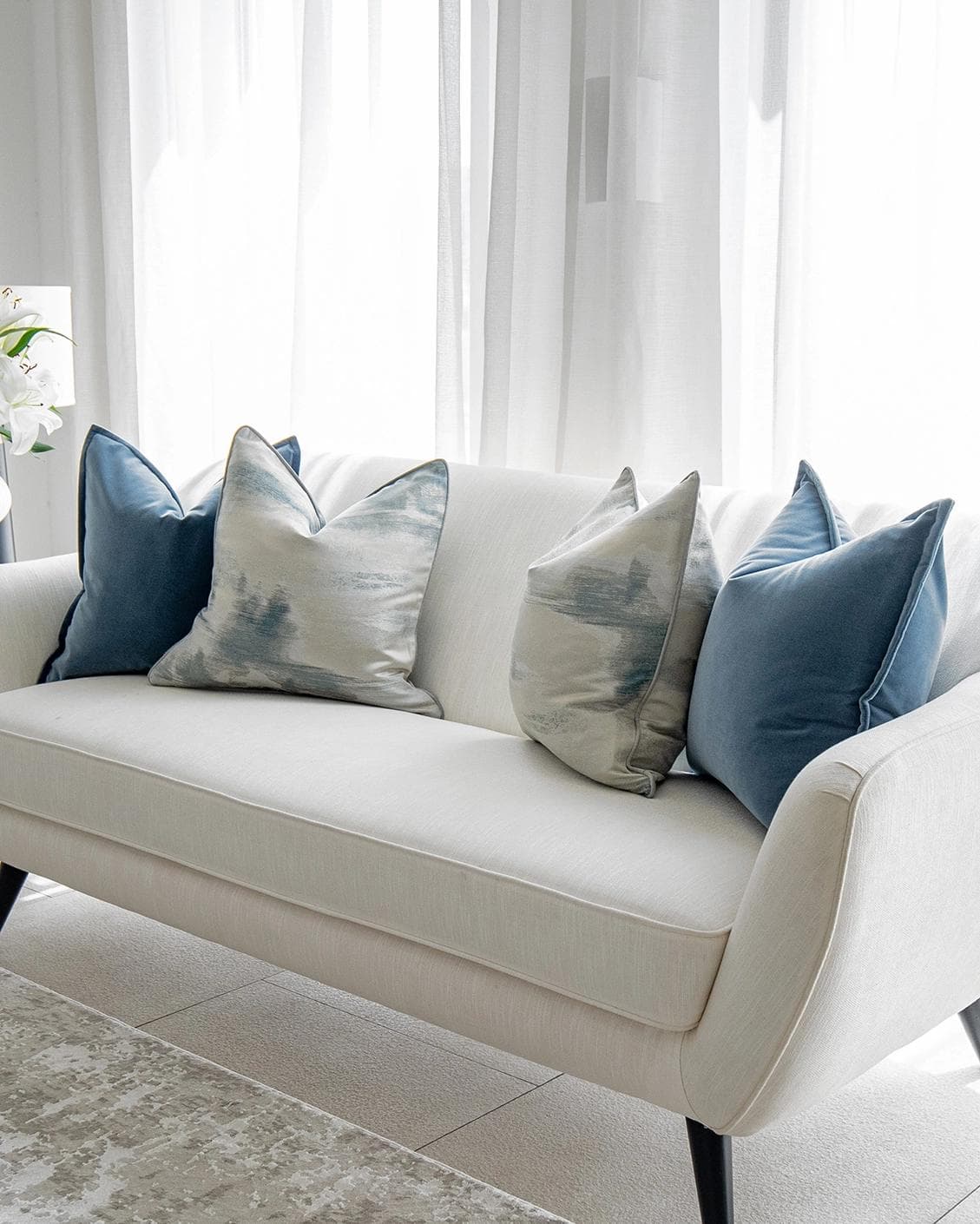 Francine Bundle cushion in blue and silver, shown in a lifestyle right view as image 2