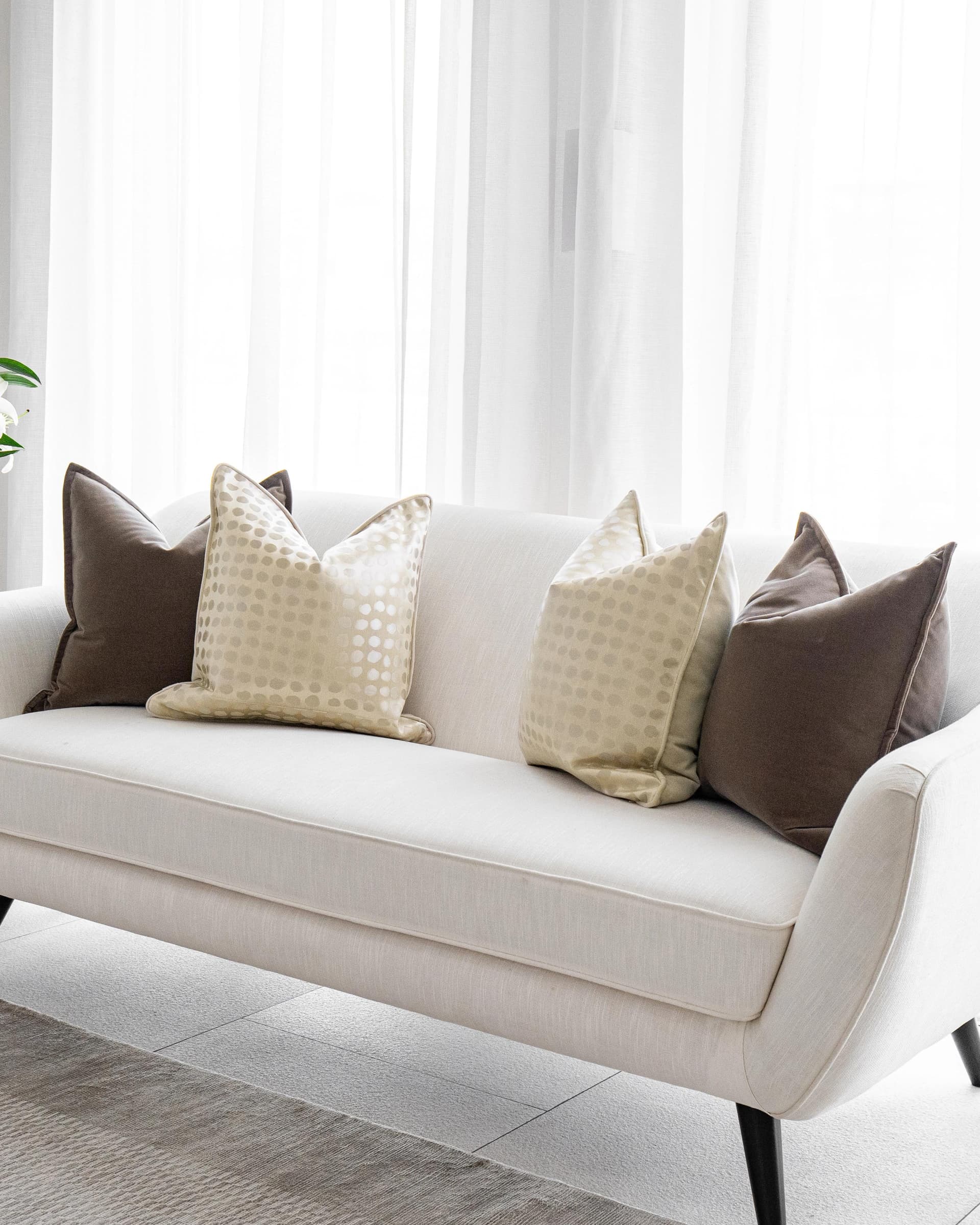 Flora Bundle cushion in brown, beige and gold, shown in a lifestyle right view as image 2