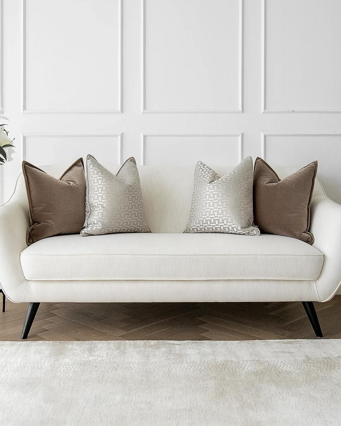 Elsie Bundle cushion in brown, beige and silver, shown in a lifestyle front view as image 4