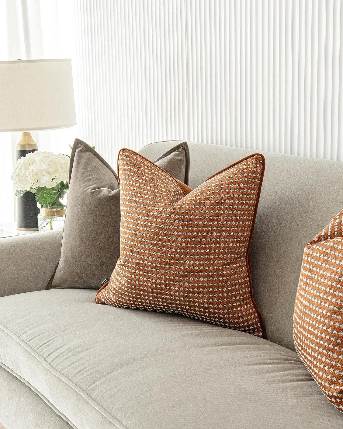 Kalysta Bundle cushion in brown and orange, shown in a lifestyle right view as image 5