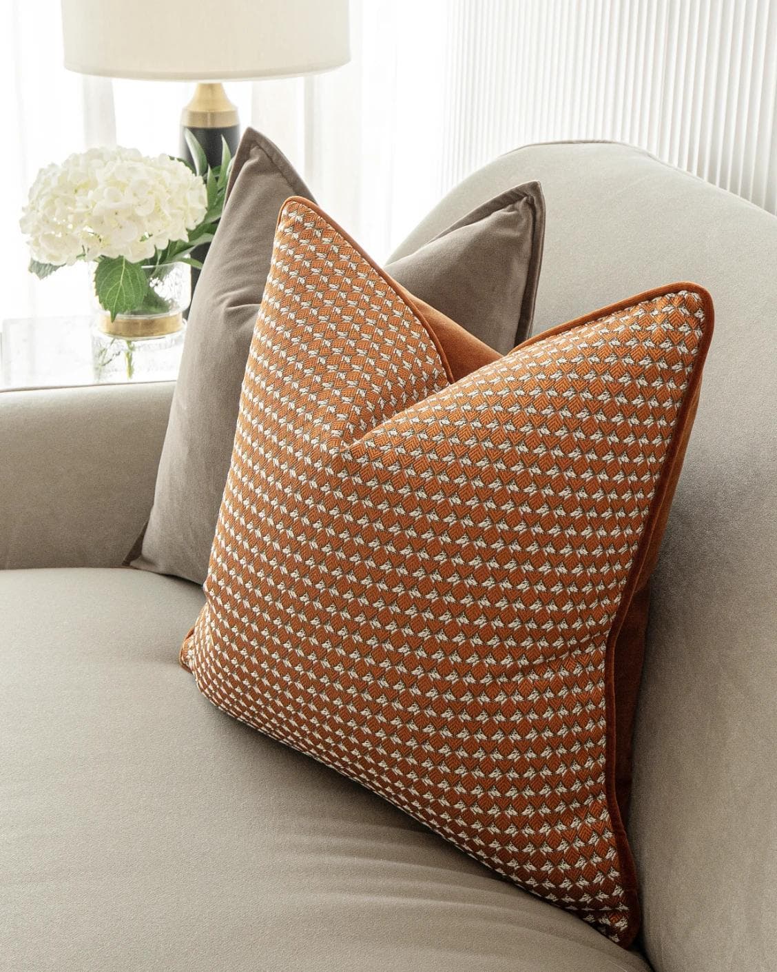 Kalysta Bundle cushion in brown and orange, shown in a lifestyle right view as image 6