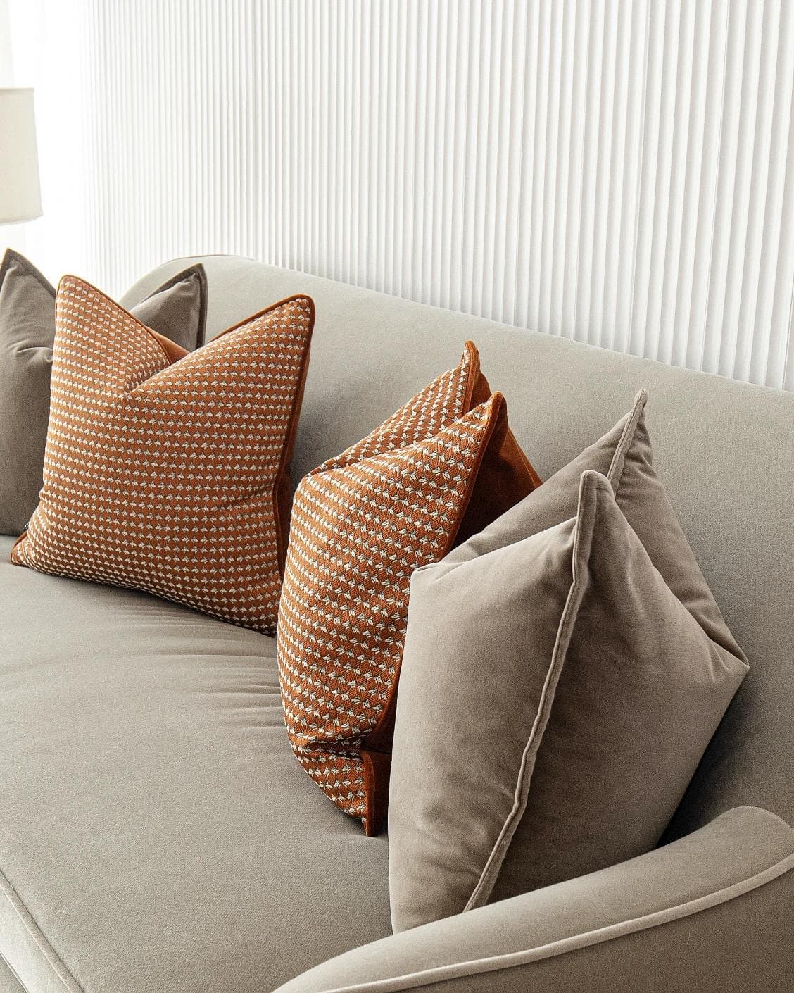Kalysta Bundle cushion in brown and orange, shown in a product right view as image 7