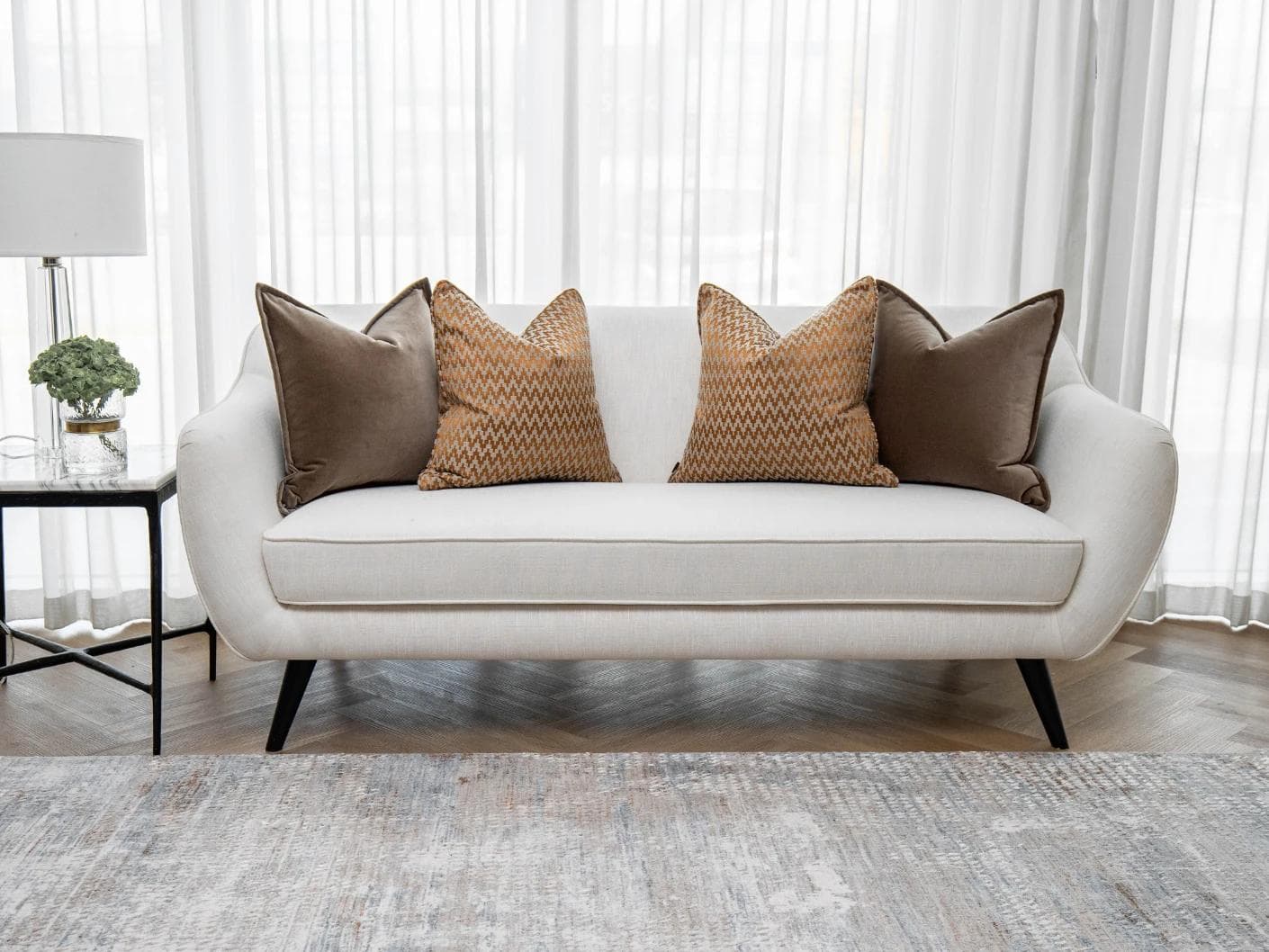 Vicente Bundle cushion in brown and orange, shown in a lifestyle front view as image 4