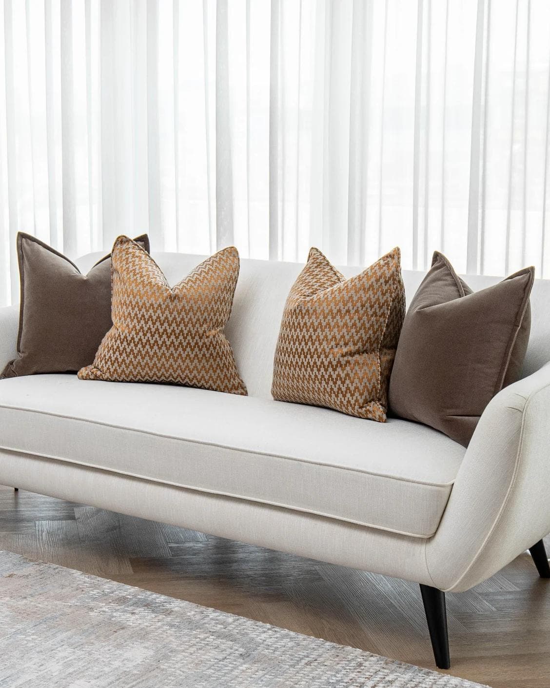 Vicente Bundle cushion in brown and orange, shown in a lifestyle right view as image 2