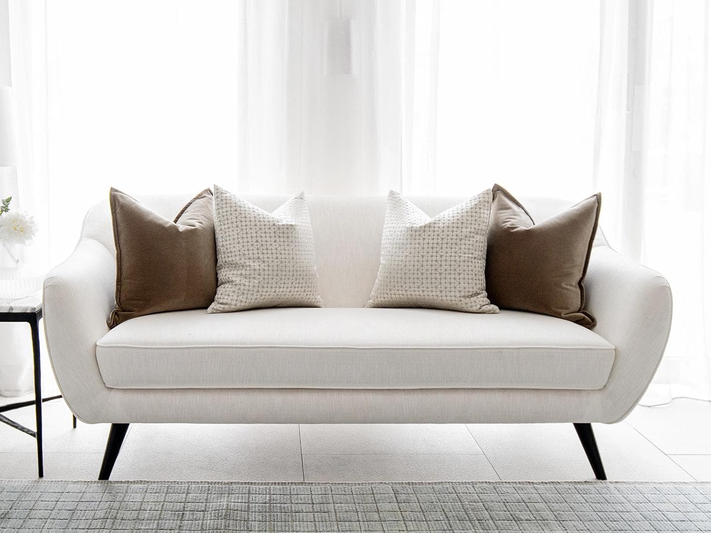 Farah Bundle cushion in brown and silver, shown in a lifestyle front view as image 4