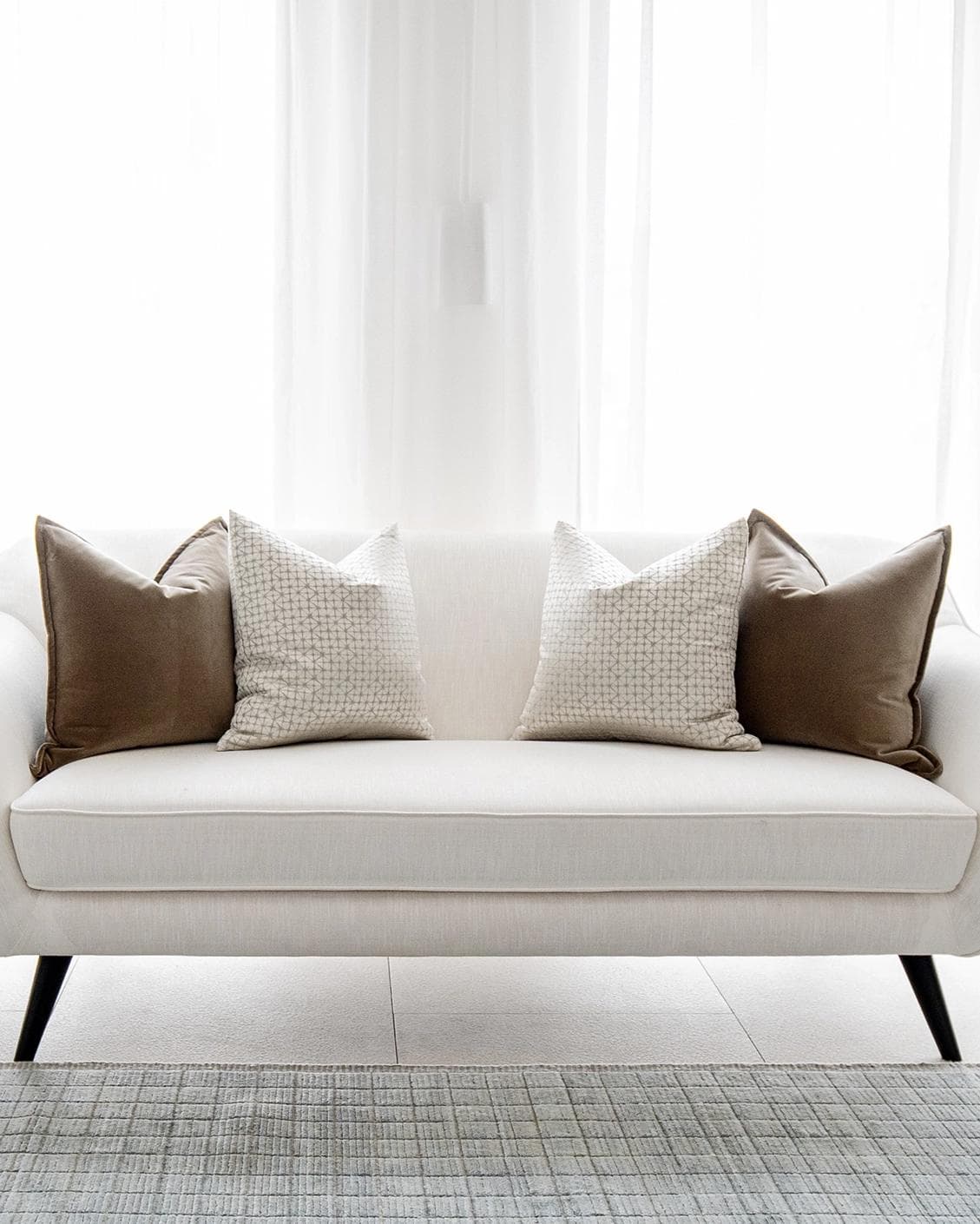 Farah Bundle cushion in brown and silver, shown in a lifestyle front view as image 4