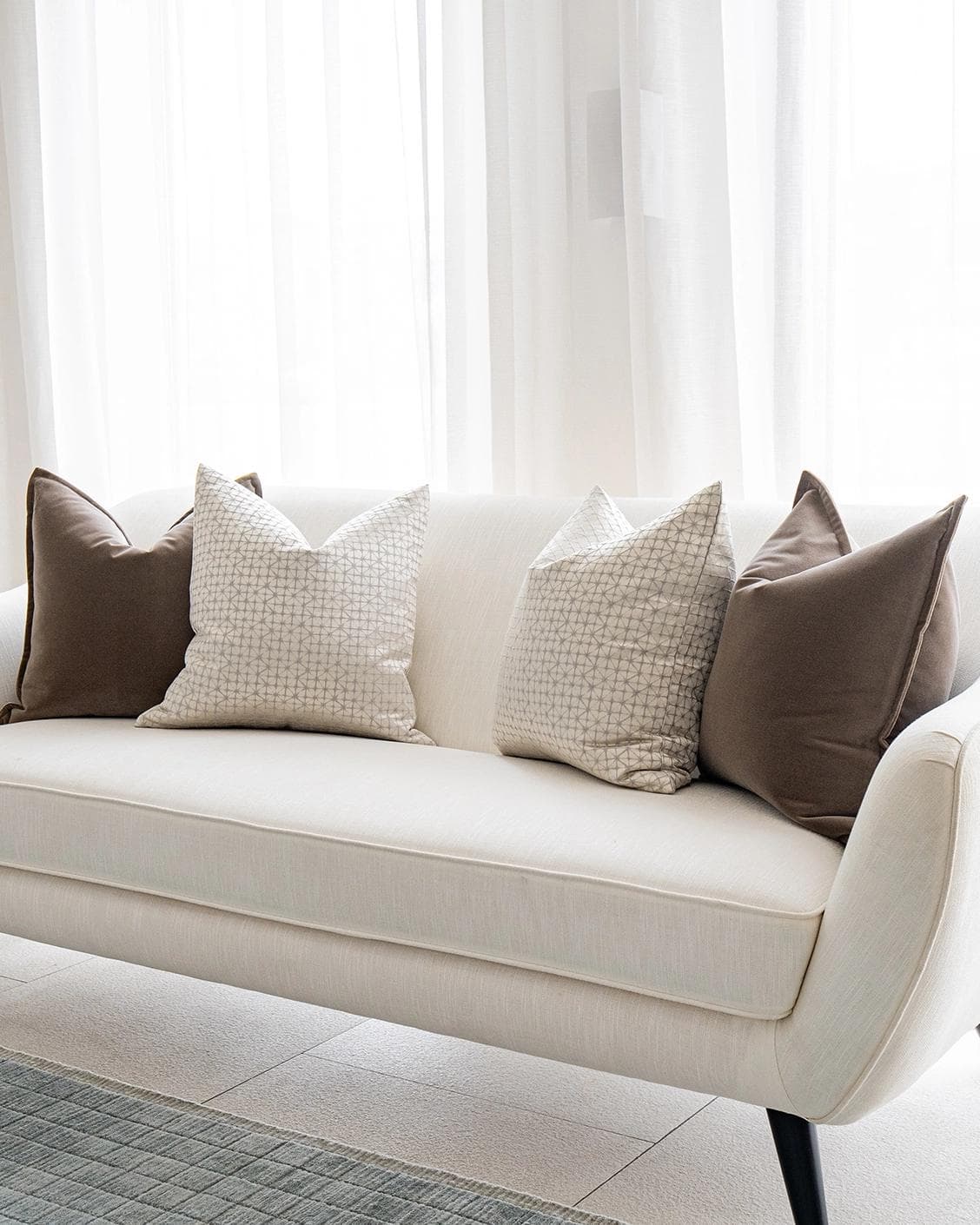 Farah Bundle cushion in brown and silver, shown in a lifestyle right view as image 2