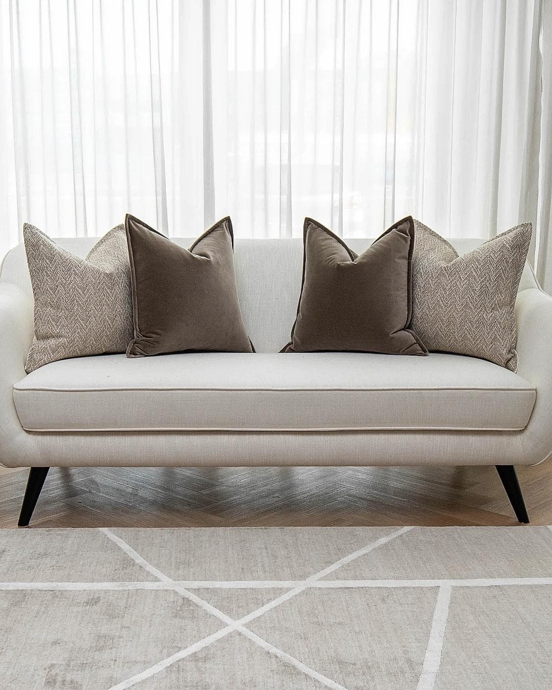 Fernando Bundle cushion in brown and beige, shown in a lifestyle front view as image 4