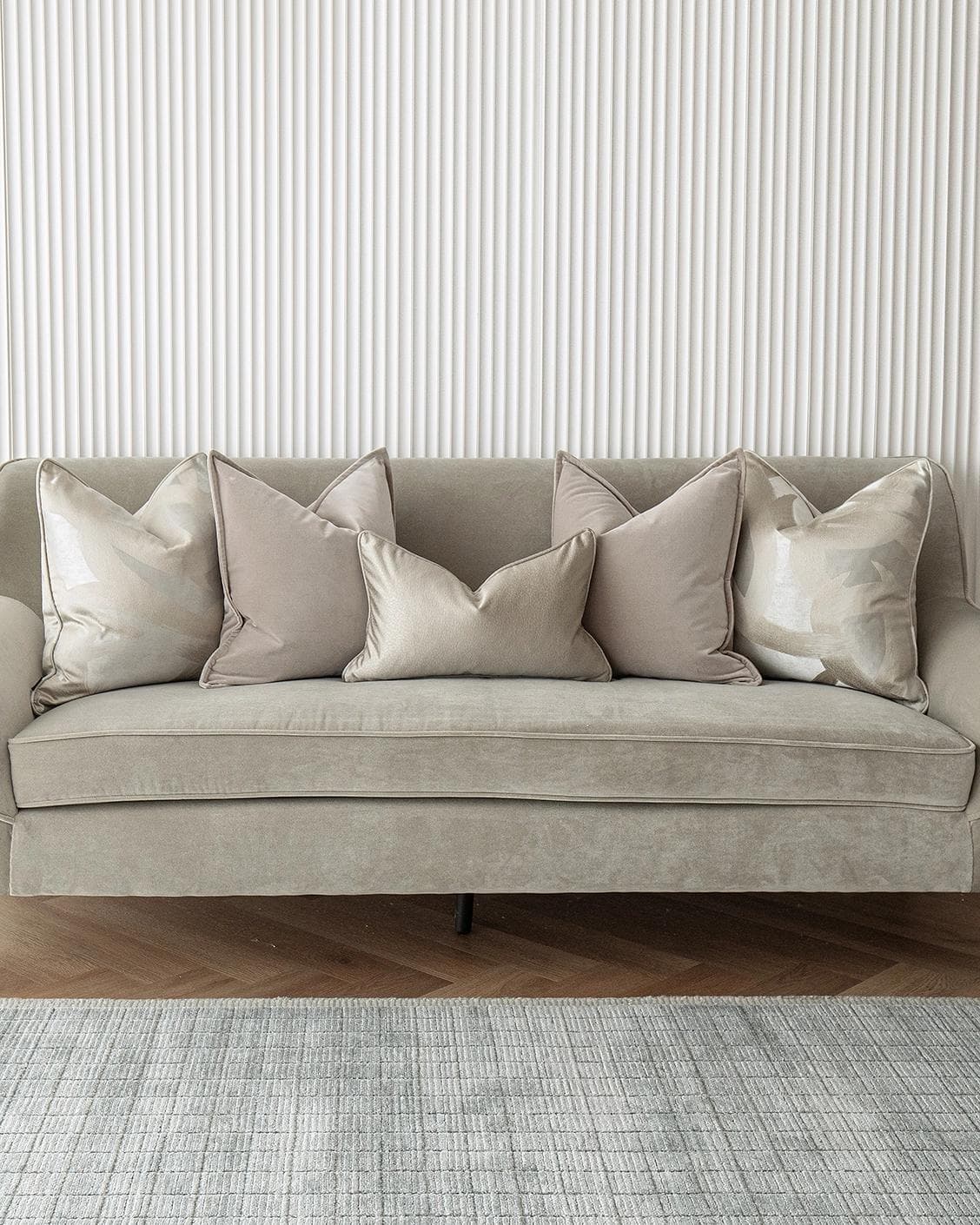 Spencer Bundle cushion in beige and silver, shown in a lifestyle front view as image 2