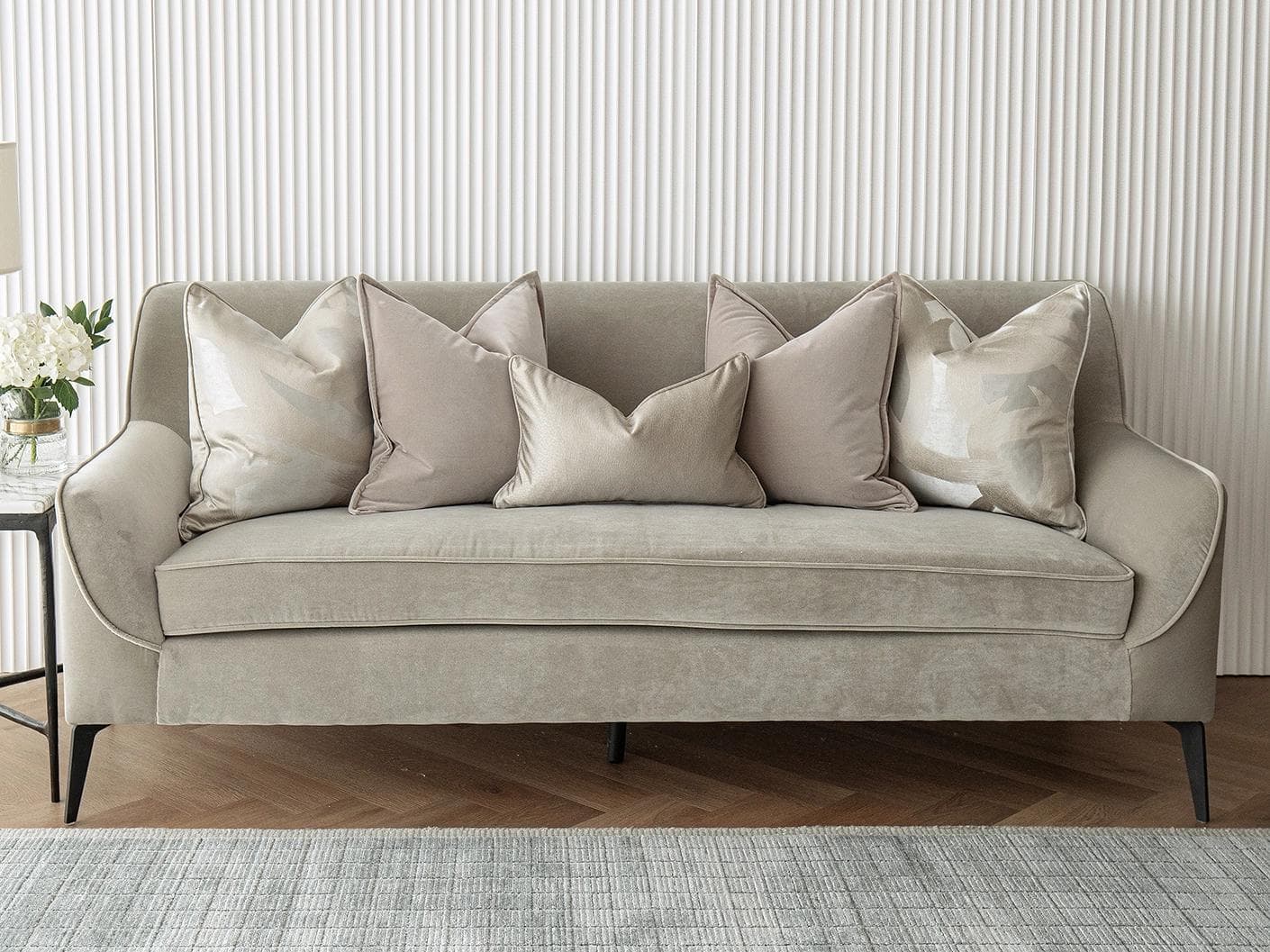 Spencer Bundle cushion in beige and silver, shown in a lifestyle front view as image 2