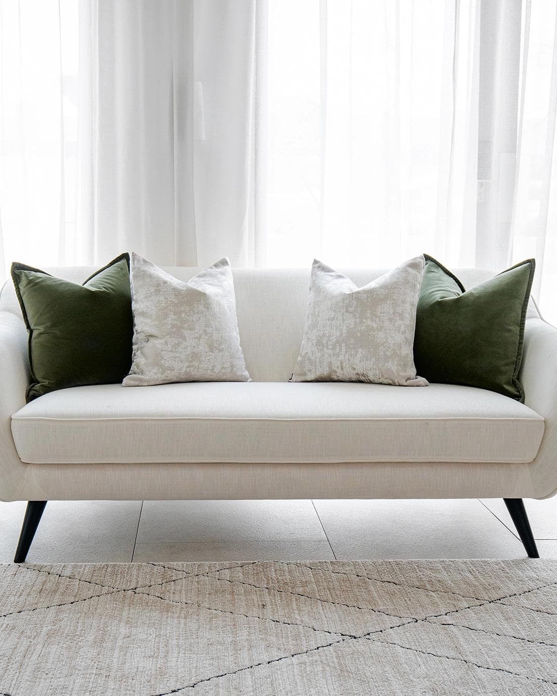 Jayce Bundle cushion in forest green, silver, grey and green, shown in a lifestyle front view as image 4