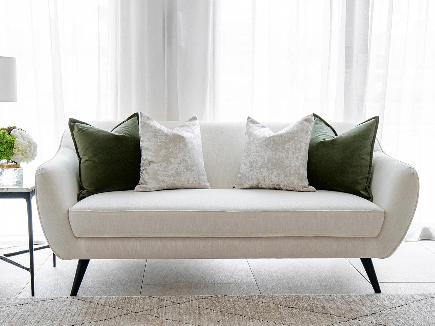 Jayce Bundle cushion in forest green, silver, grey and green, shown in a lifestyle front view as image 4
